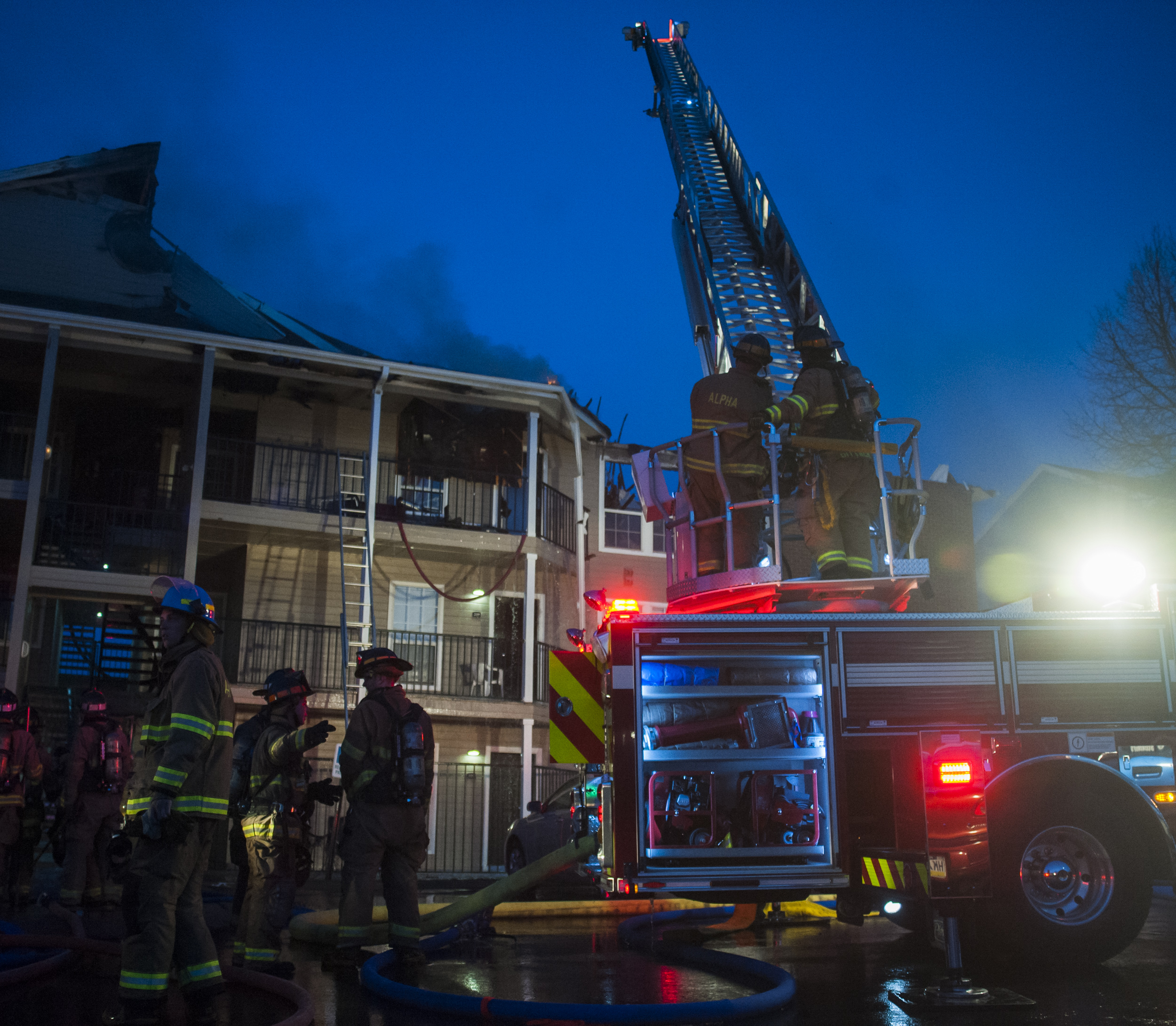Members of Alpha Fire Co. work on extinguishing and clearing building 14 of The Park Apartments on Wednesday, April 20, 2016.
