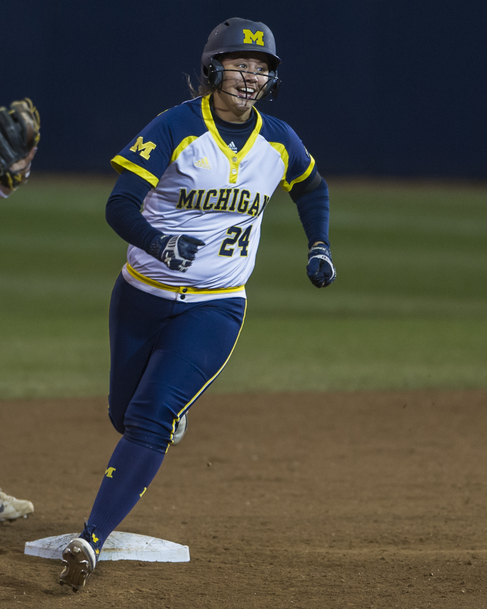 Michigan first baseman Tera Blanco smiles as she rounds second base after hitting a home run in the final game of the Big Ten Tournament against Minnesota on Saturday, May 14, 2016.