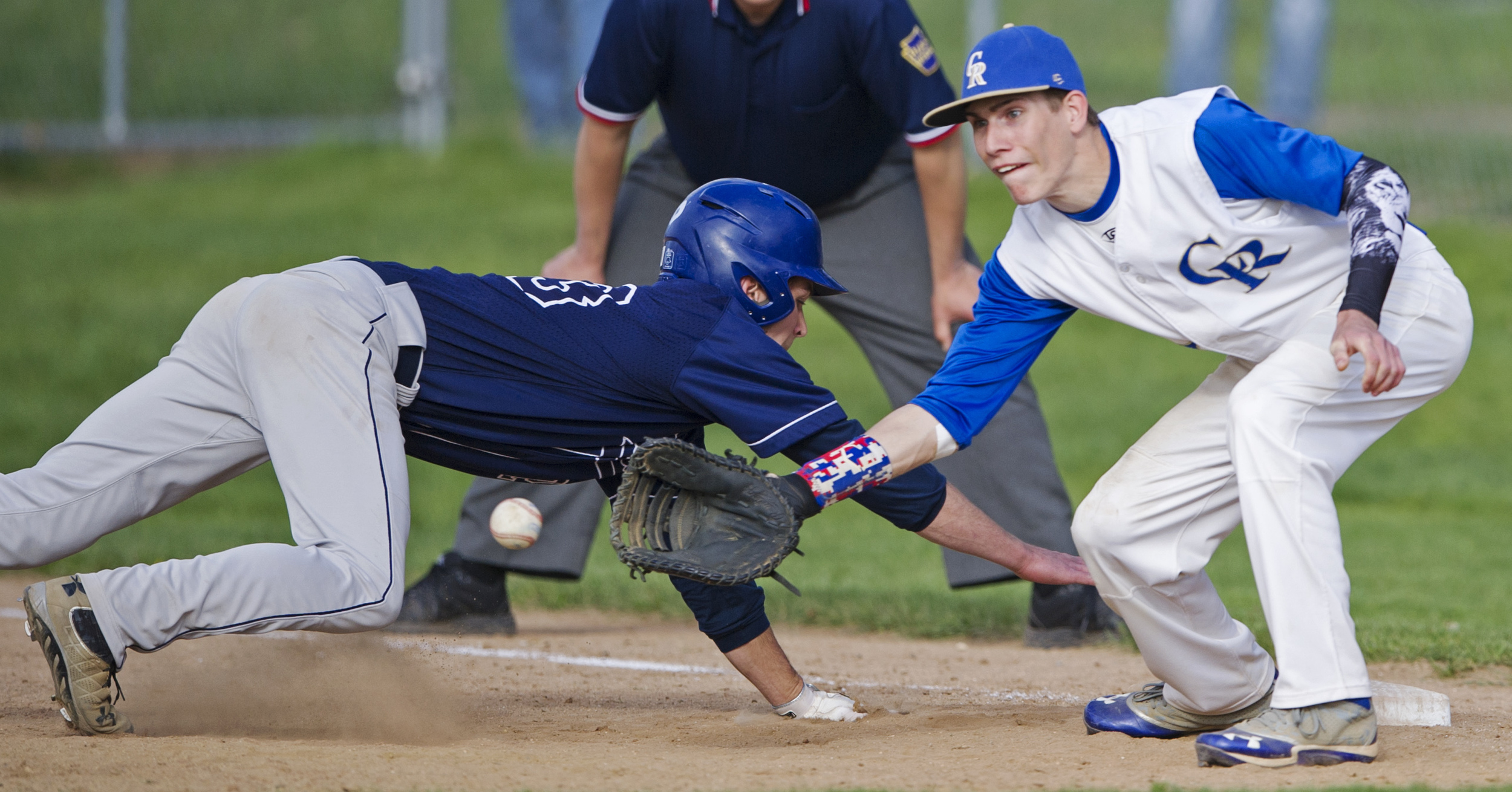 Chestnut Ridge first baseman Shawn Brady leans to catch a throw from the pitcher as Phillipsburg-Osceola center fielder Caleb Belinda dives back to base after trying to steal second during the game at Phillipsburg on Thursday, May 19, 2016. Phillipsburg won the game 4-3 in extra innings.