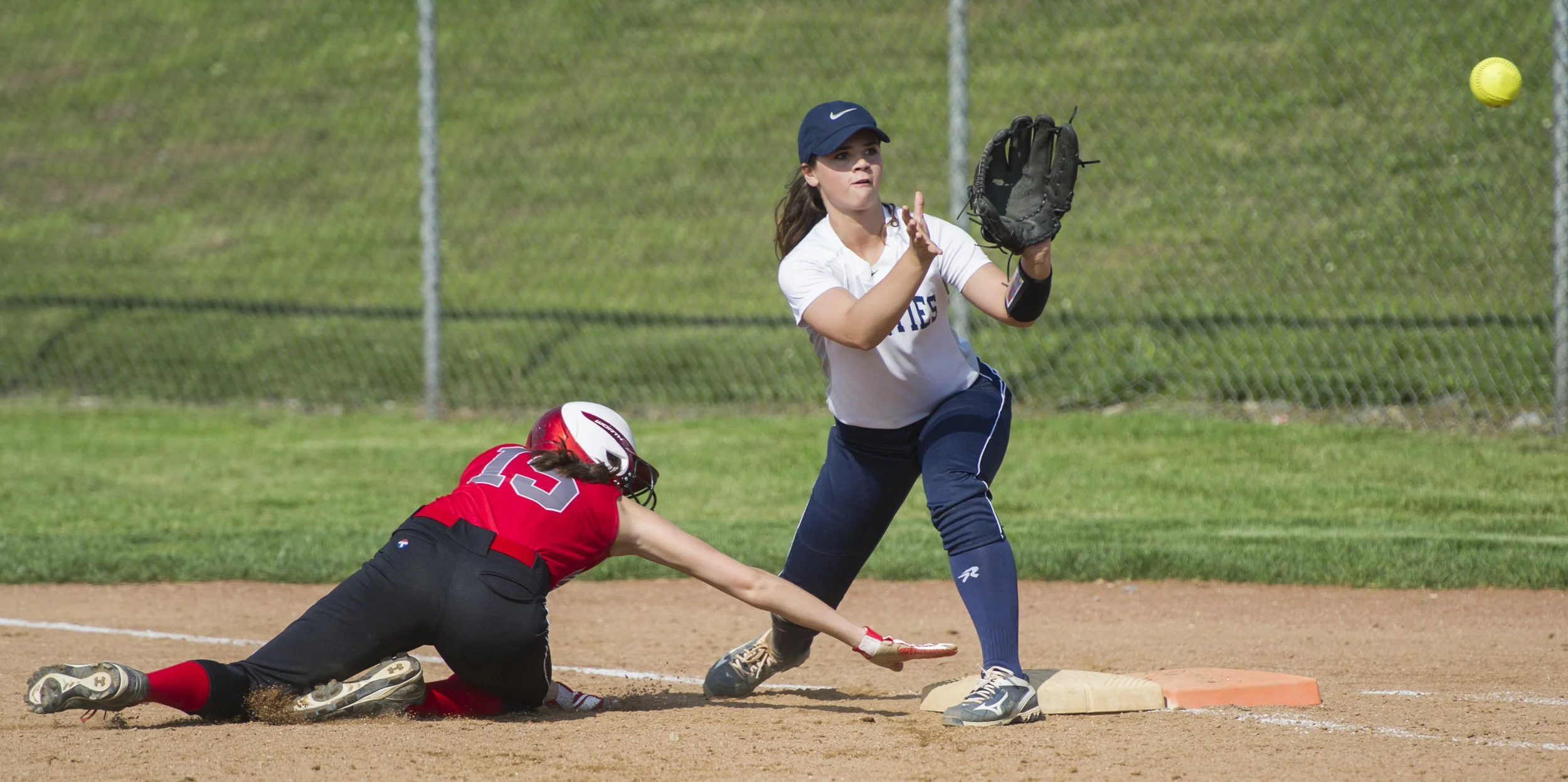 Phillipsburg-Osceola first baseman Maggie Peck lines up to catch a throw from the catcher after Westmont center fielder Katie Flick is caught trying to steal second base during the playoff game at Phillipsburg on Monday, May 23, 2016. Phillipsburg won the game 9-0.