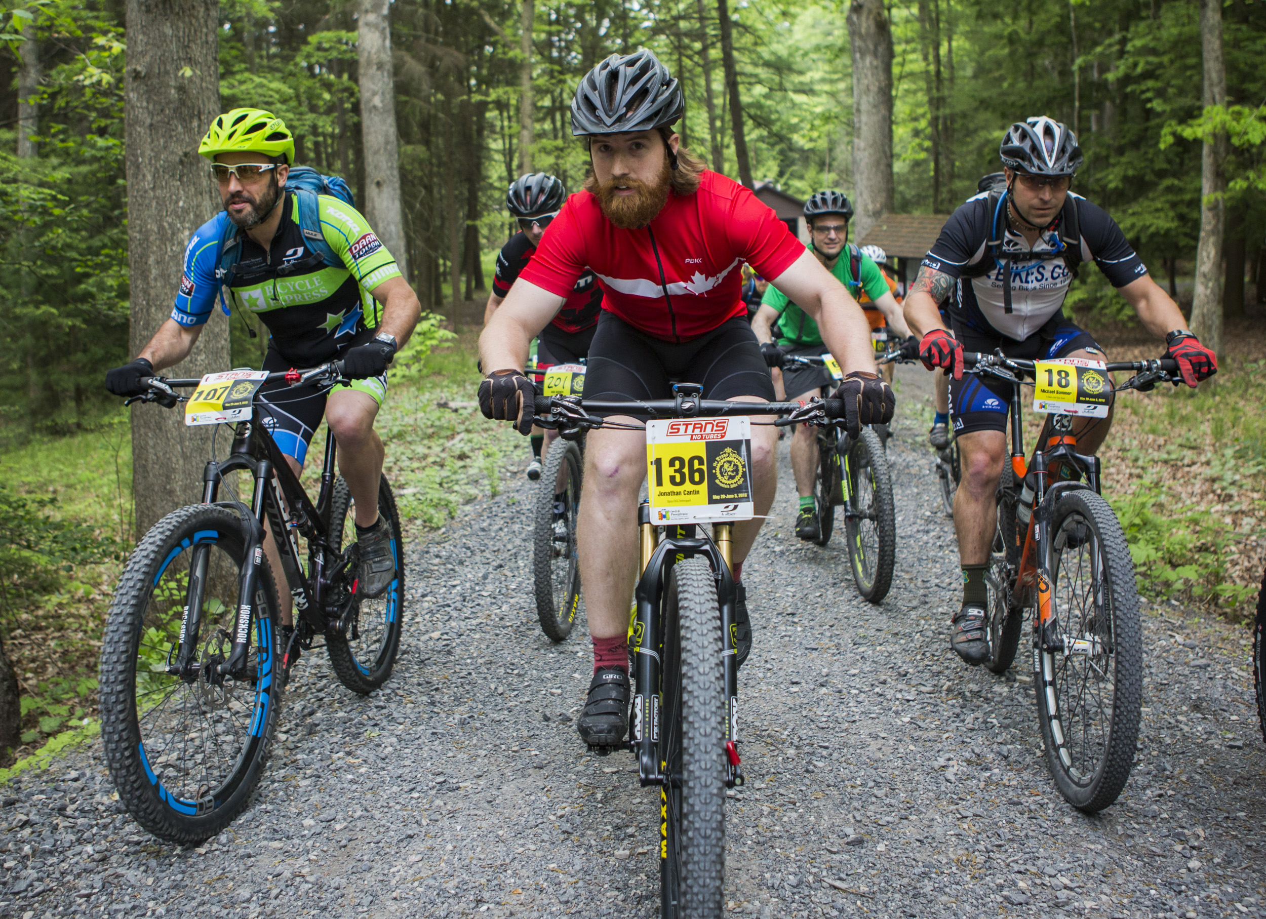 Jonathan Cantin pedals up the path from the starting line of the fourth stage of the Tran-Sylvania Epic Mountain Bike Ride in the main parking lot of R.B. Winter State Park surrounded by other riders on Thursday, June 2, 2016