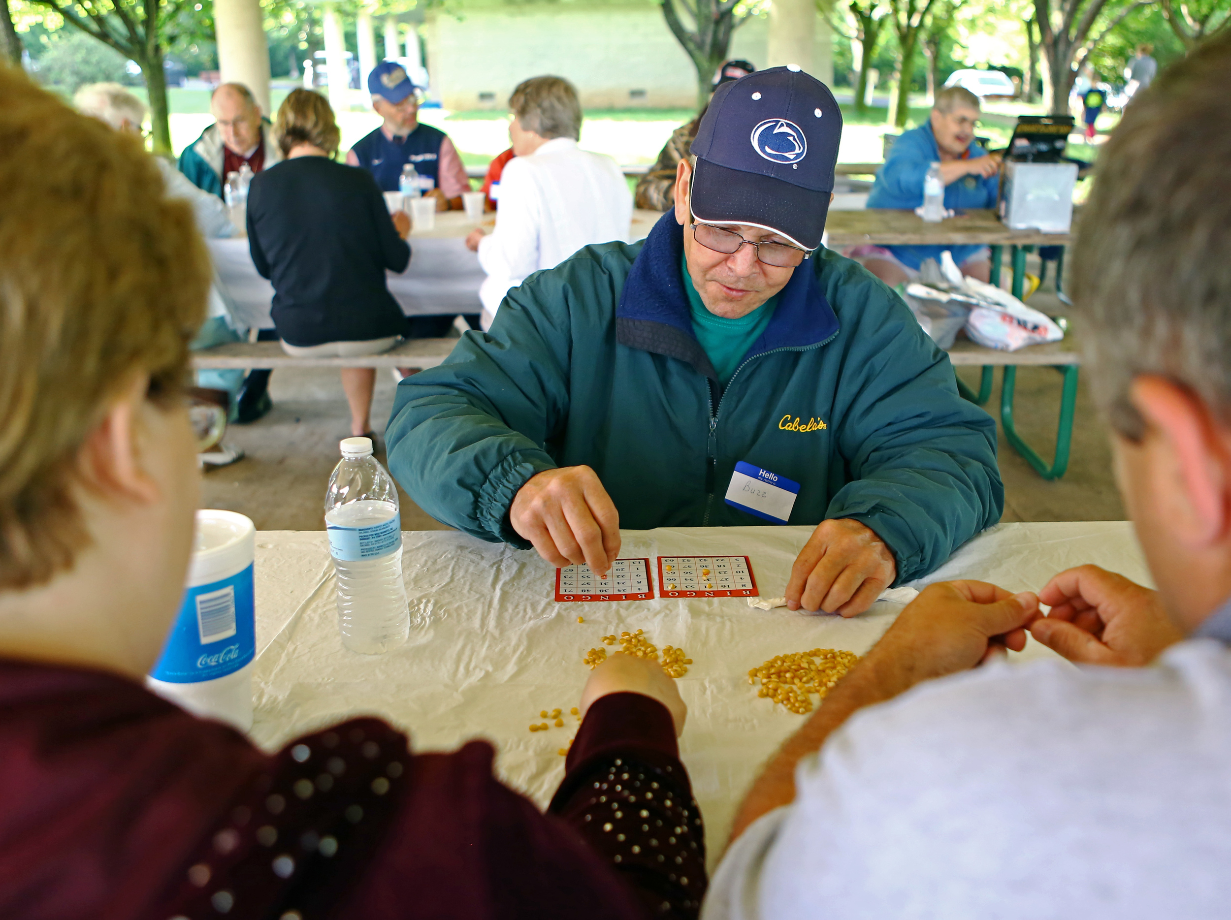 Cancer survivor Buzz McGee places popcorn kernels on on a bingo card during the Cancer Survivors Association picnic held at Tom Tudek Memorial Park on Sunday, June 5, 2016. McGee has been free of non-hodgkin's lymphoma for five years.