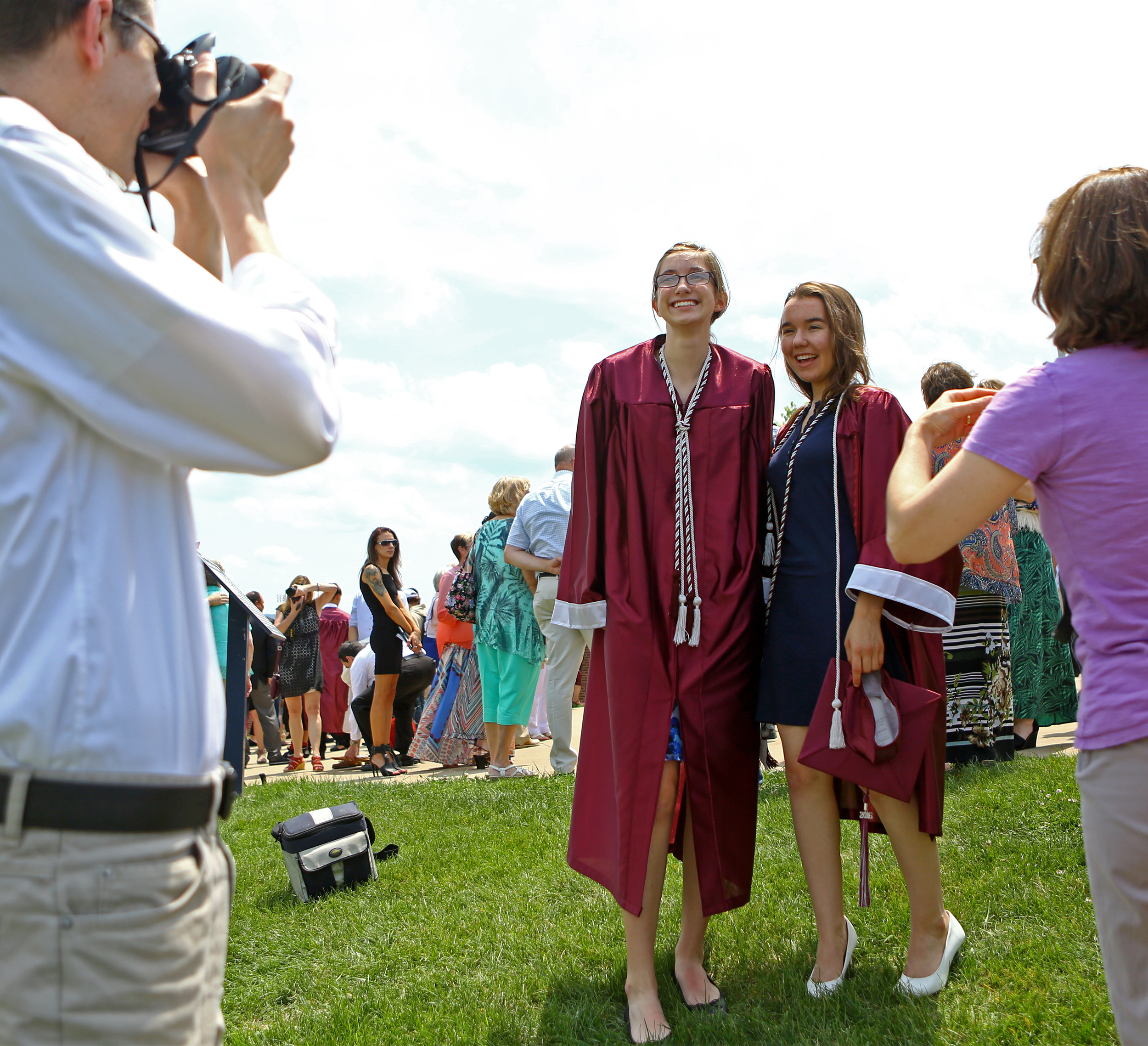 Bethany Parkinson, left, and Natalie Farnsworth, right, pose ofr photos outside of the Bryce Jordan Center following the State College Area High School commencement ceremony on Saturday, June 11, 2016.