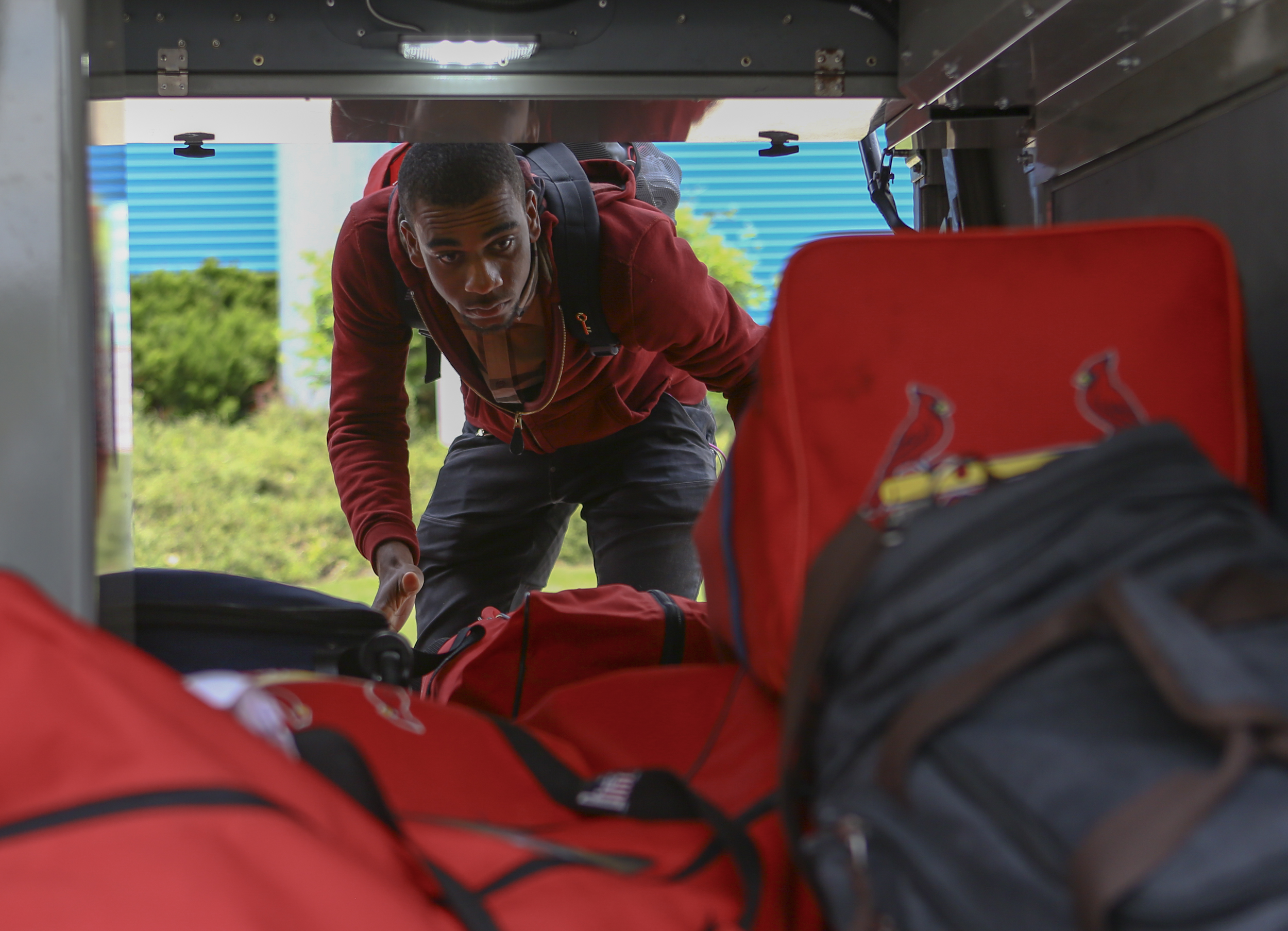 State College Spikes pitcher Jhonatan Escudero grabs luggage from the bus during the team's arrival to State College at medlar Field on Saturday, June 11, 2016.