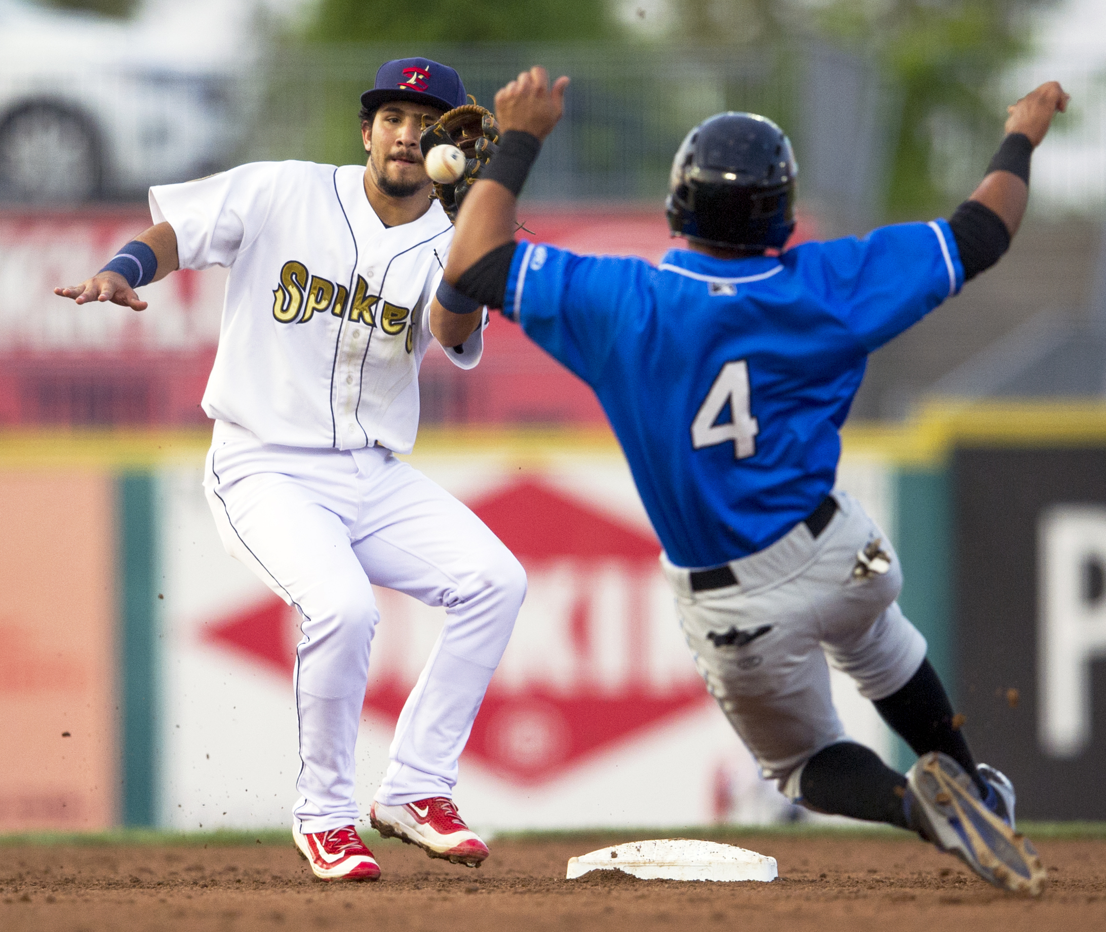 State College Spikes short stop Jose Martinez catches the ball to tag out Hudson Valley Renegades center fielder Oscar Rojas as he slides to second base during the second game of the series at Medlar Field on Monday, June 20, 2016.