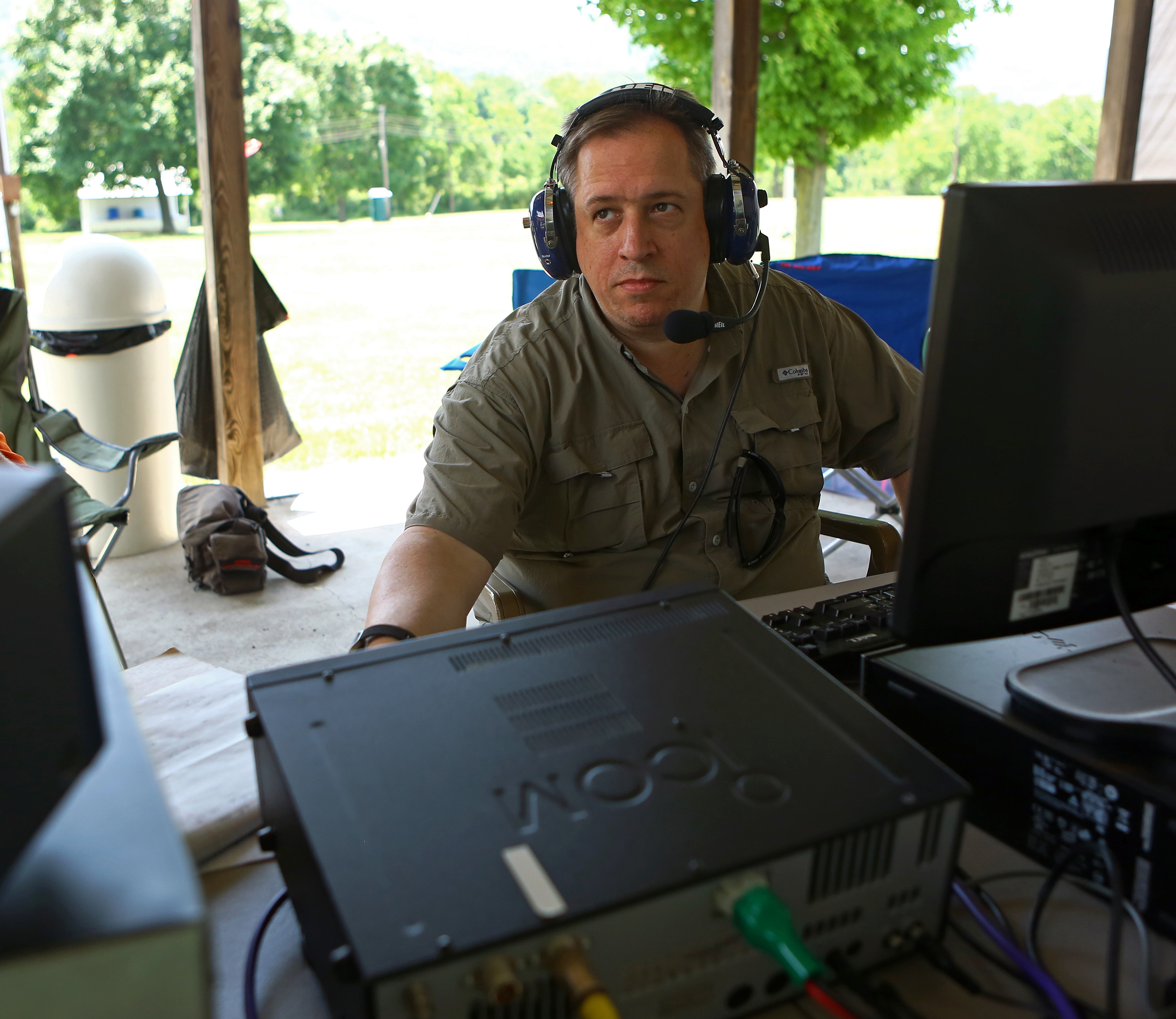 Dave Ritz, call sign NK3X, of State College listens in on the 40 meter band for potential contacts to make during the Nittany Amateur Radio Club's field day at the Pleasant Gap Fire Company carnival grounds on Sunday, June 26, 2016.