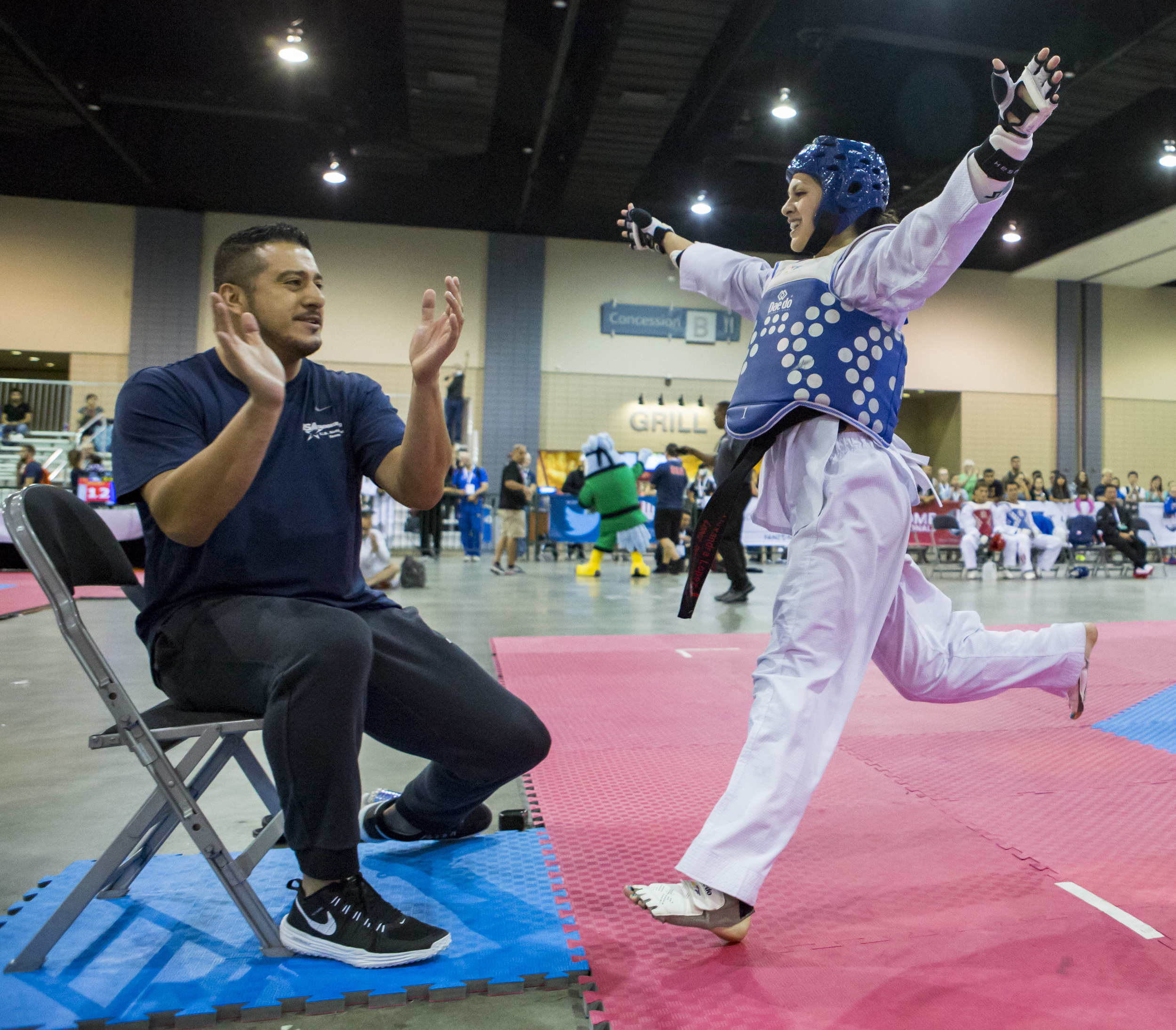 Alexandra Lopez and her coach celebrate after winning a final sparring match in the USA Taekwondo National Championships held at the Greater Richmond Convention Center in Richmond, Va. on Thursday, July 7, 2016.