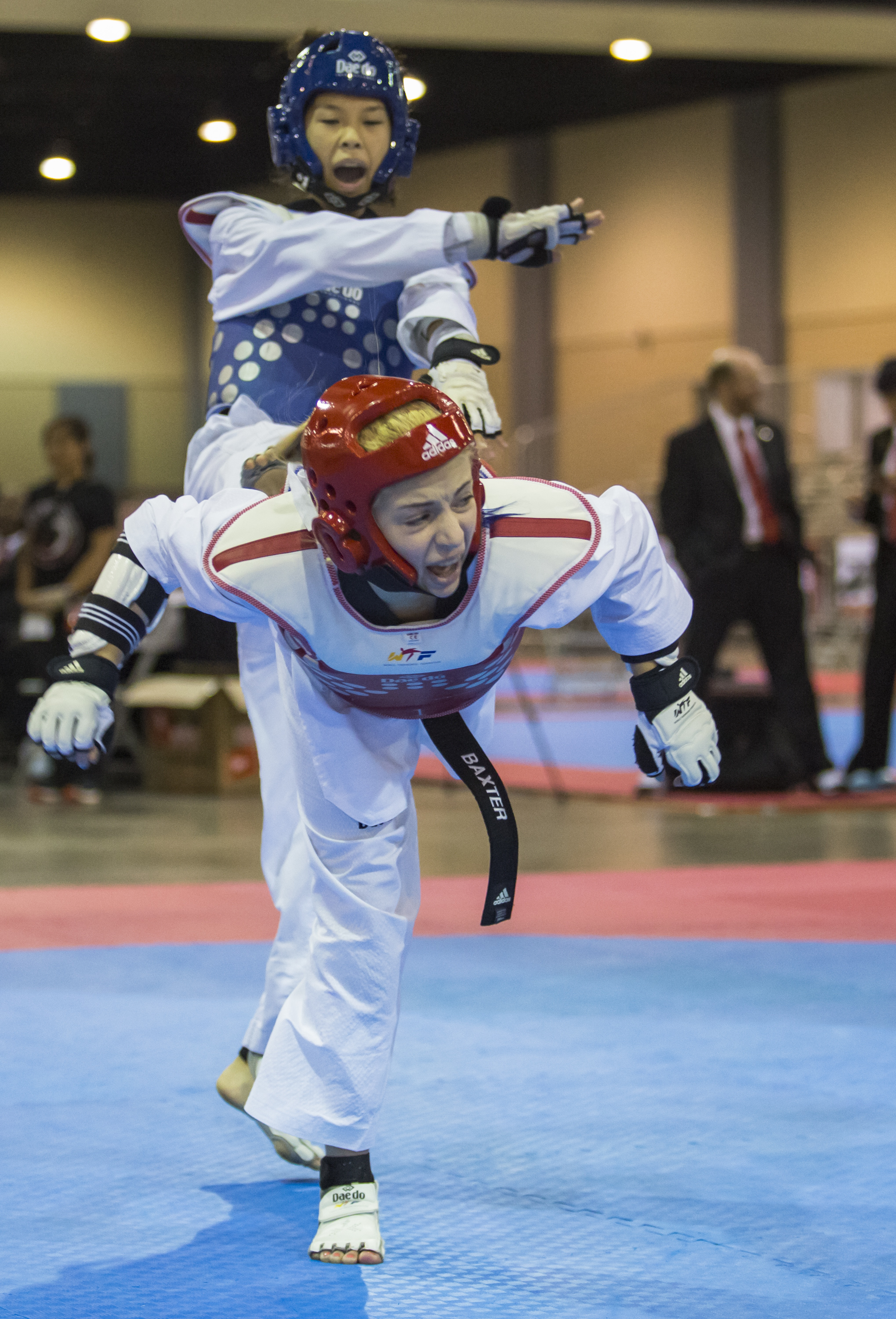 Olivia Baxter delivers a spin kick to Marissa Mahanag's chest in the 37-41 kilogram black belt final match up during the USA Taekwondo National Championships held at the Greater Richmond Convention Center in Richmond, Va. on Saturday, July 9 , 2016.