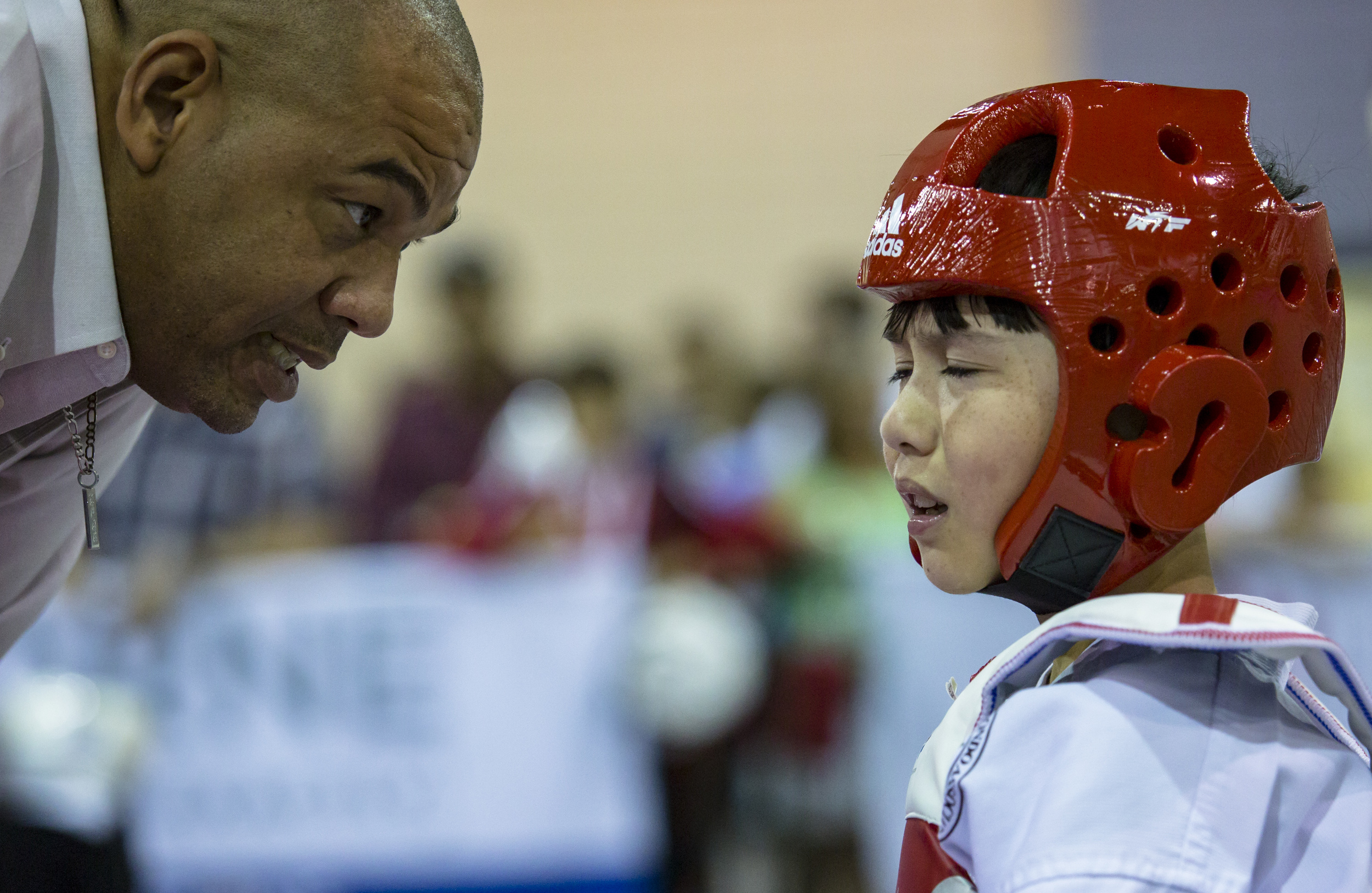Master Nigel Holder of East West Taekwondo school speaks with a frustrated Alexander Pease between rounds in one of his sparring matches during the 2016 USA Taekwondo National Championships at the Greater Richmond Convention Center on Saturday, July 9, 2016.