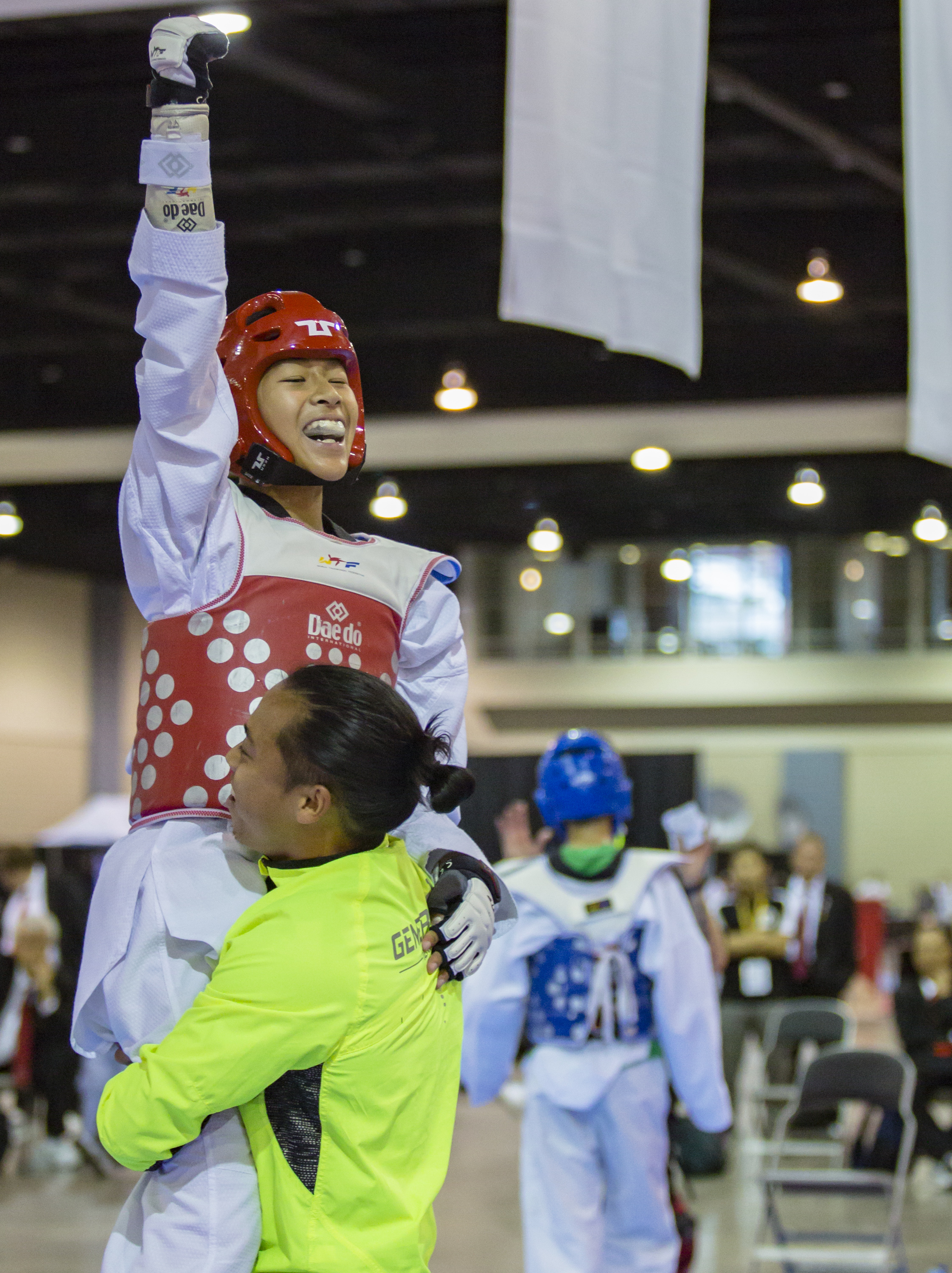 Kyle Chan is lifted by his coach Chino Cruz after winning the under 49 kilogram black belt final over Christopher May during the USA Taekwondo National Championships held at the Greater Richmond Convention Center in Richmond, Va. on Saturday, July 9, 2016.