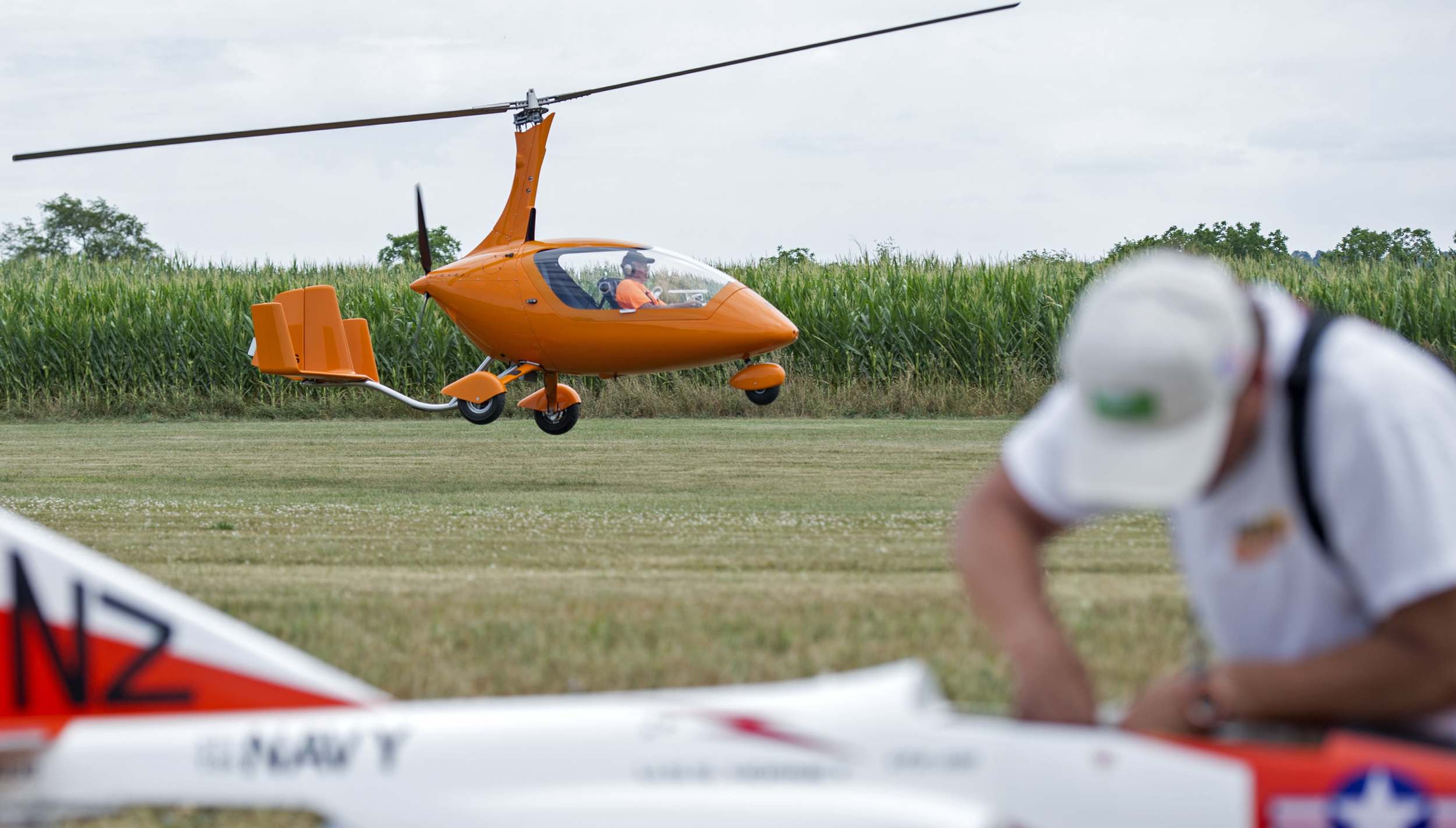 Bob Grove of Centre Hall flies his Auto Gyroplane off of the runway at Centre Airpark as Robert Schneck prepares his model jet powered radio controlled plane during the State College Radio Control Club Air Show on Sunday, July 24, 2016.