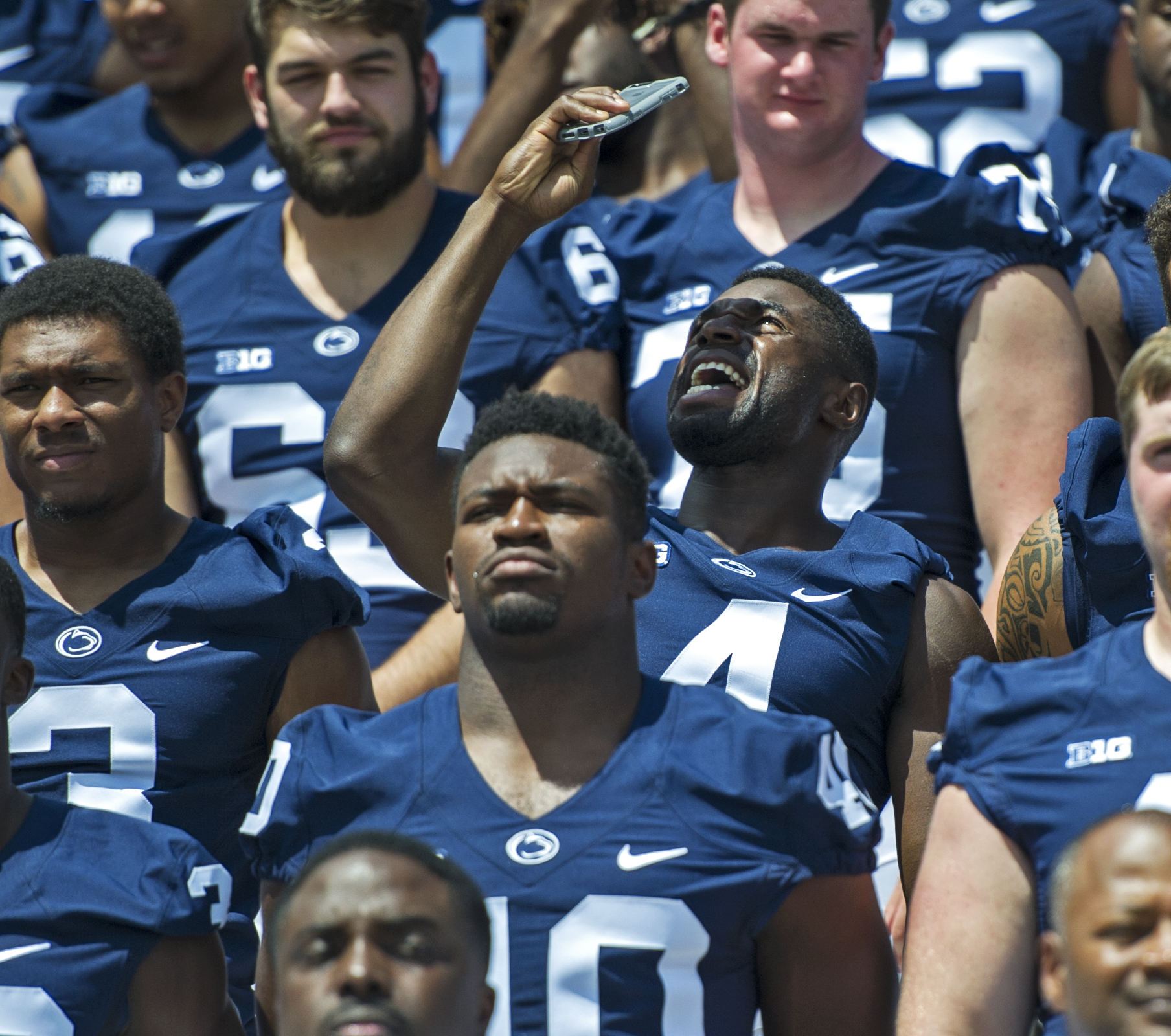 Sophomore center back Nick Scott takes a quick selfie between takes of the team's group photo during photo day at Beaver Stadium on Sunday, Aug. 7, 2016.