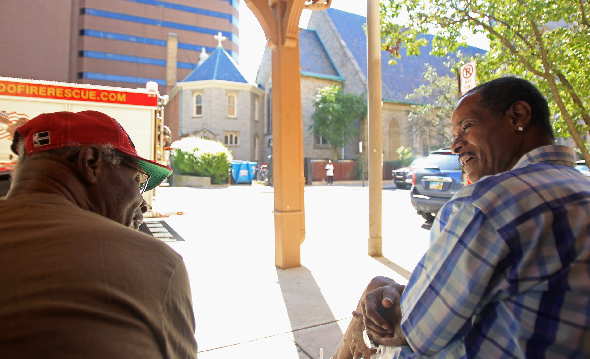  James Moss, left, chats with James Hughes on the sidewalk of St. Clair street in downtown Toledo outside of Renaissance Senior Apartments on Tuesday, Sept. 13, 2016. Moss and Hughes both live at the senior apartments and met at meetings at Trinity Episcopal Church across the street. 