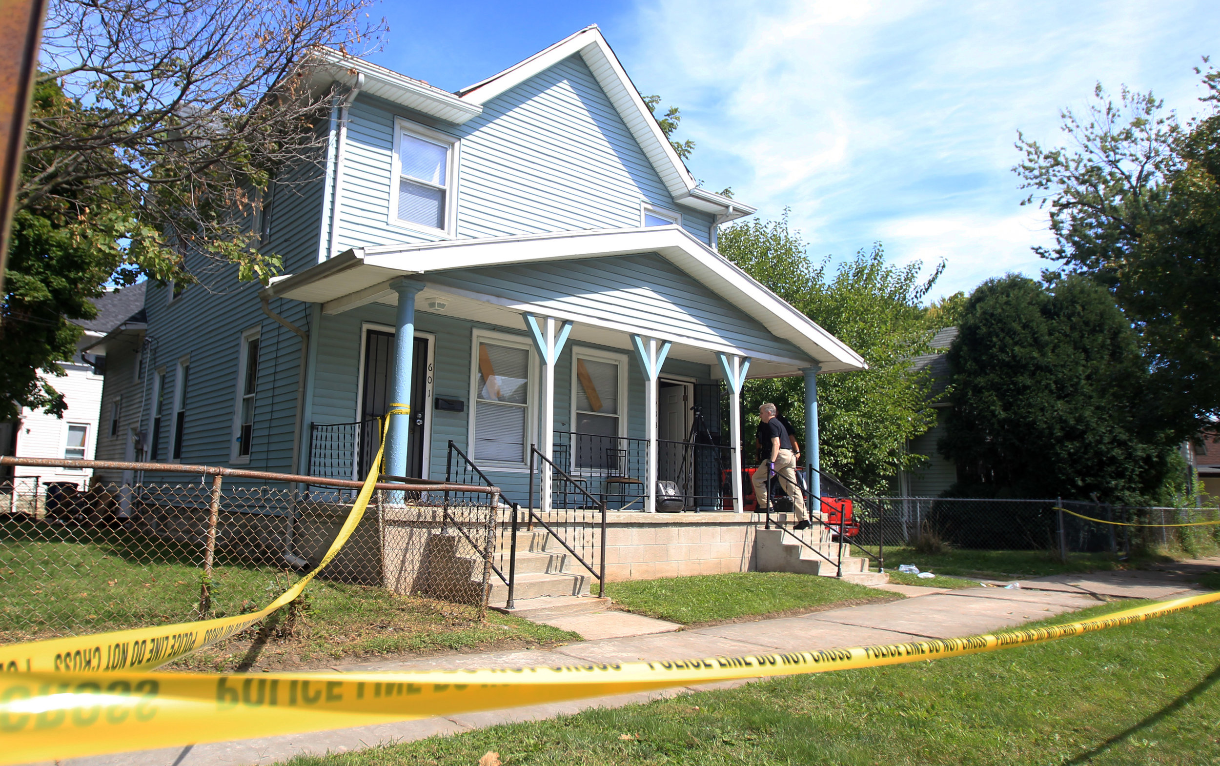 A Toledo Police Department investigator enters 603 Church Street in East Toledo to continue the investigation of the shooting in the morning of Thursday, Sept. 15 photographed on Thursday, Sept. 15, 2016.