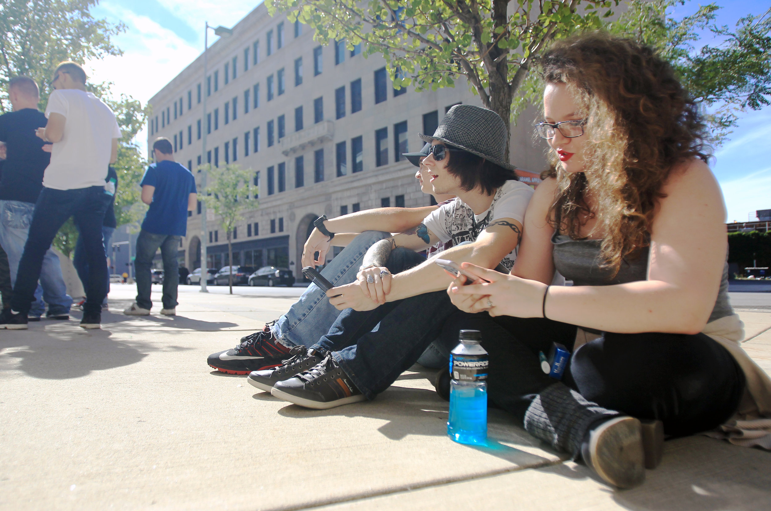 From left to right: Justin Withrow, David Spears, and Katlin Tackett of Dunbar WV. sit on the sidewalk in front of the Huntington Center in Toledo in line for the Avenged Sevenfold concert on Thursday, Sept. 15, 2016.