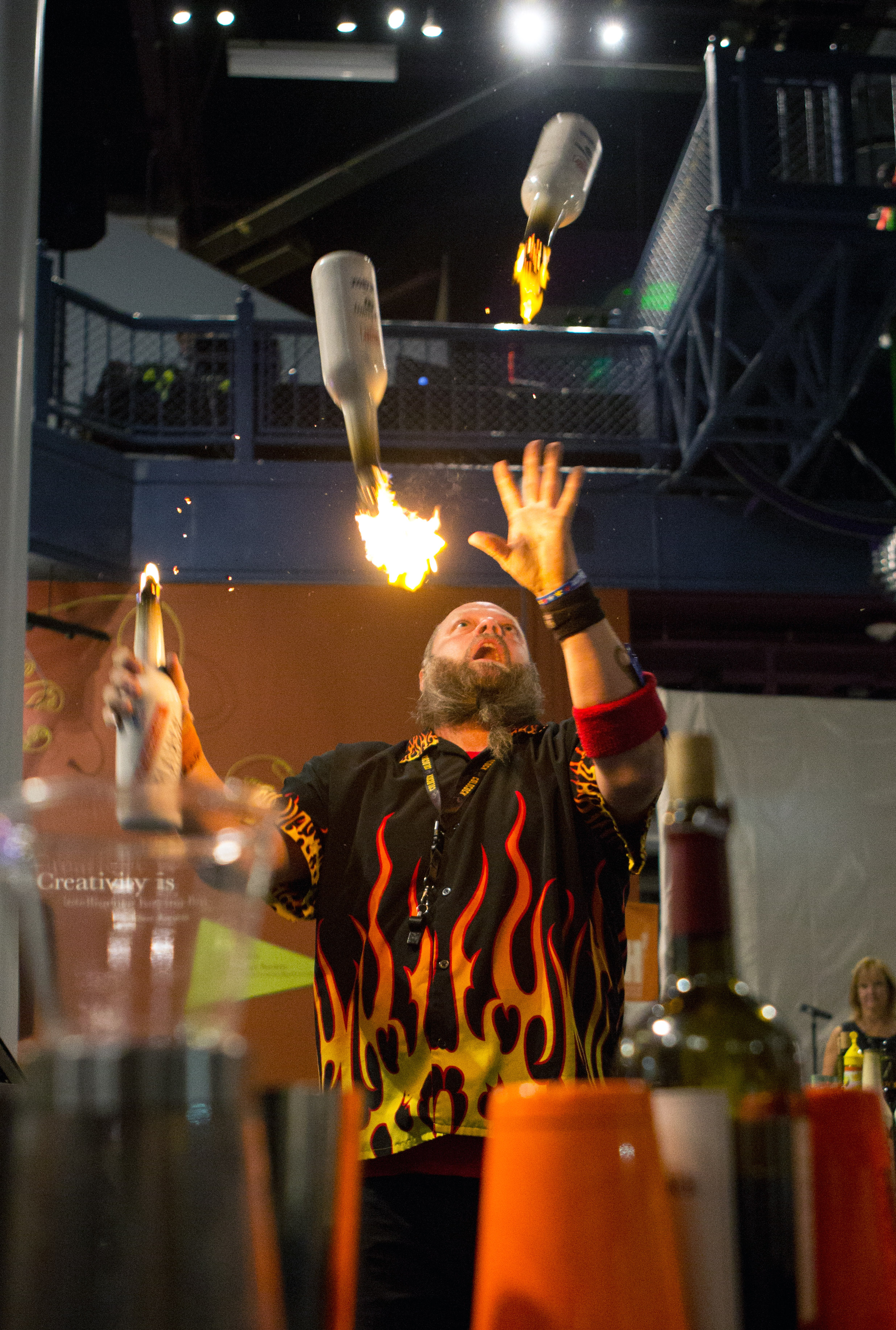  Celebrity mixologist Robbie Flair juggles flaming liquor bottles as part of a flair branding performance during the Bash 7 fundraiser at Imagination Station in downtown Toledo on Saturday, Sept. 17, 2016. 