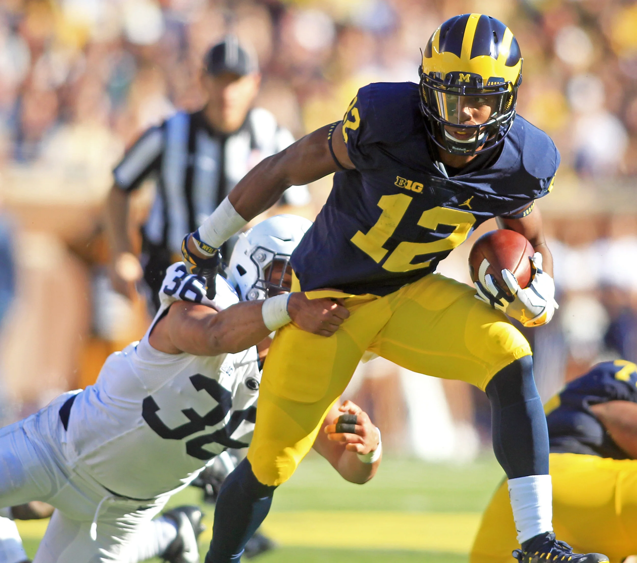 Michigan running back Chris Evans breaks a tackle from Penn State linebacker Jan Johnson during the game at "The Big House" in Ann Arbor on Saturday, Sept. 24, 2016. Michigan won the game 49-10. 
