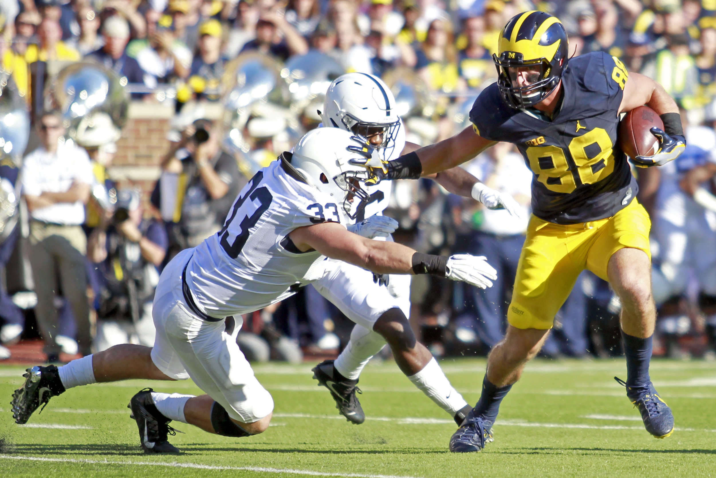 Michigan tight end Jake Butt stiff arms Penn State Jake Copper in the first half of the game at "The Big House" in Ann Arbor on Saturday, Sept. 24, 2016. Michigan won the game 49-10. 