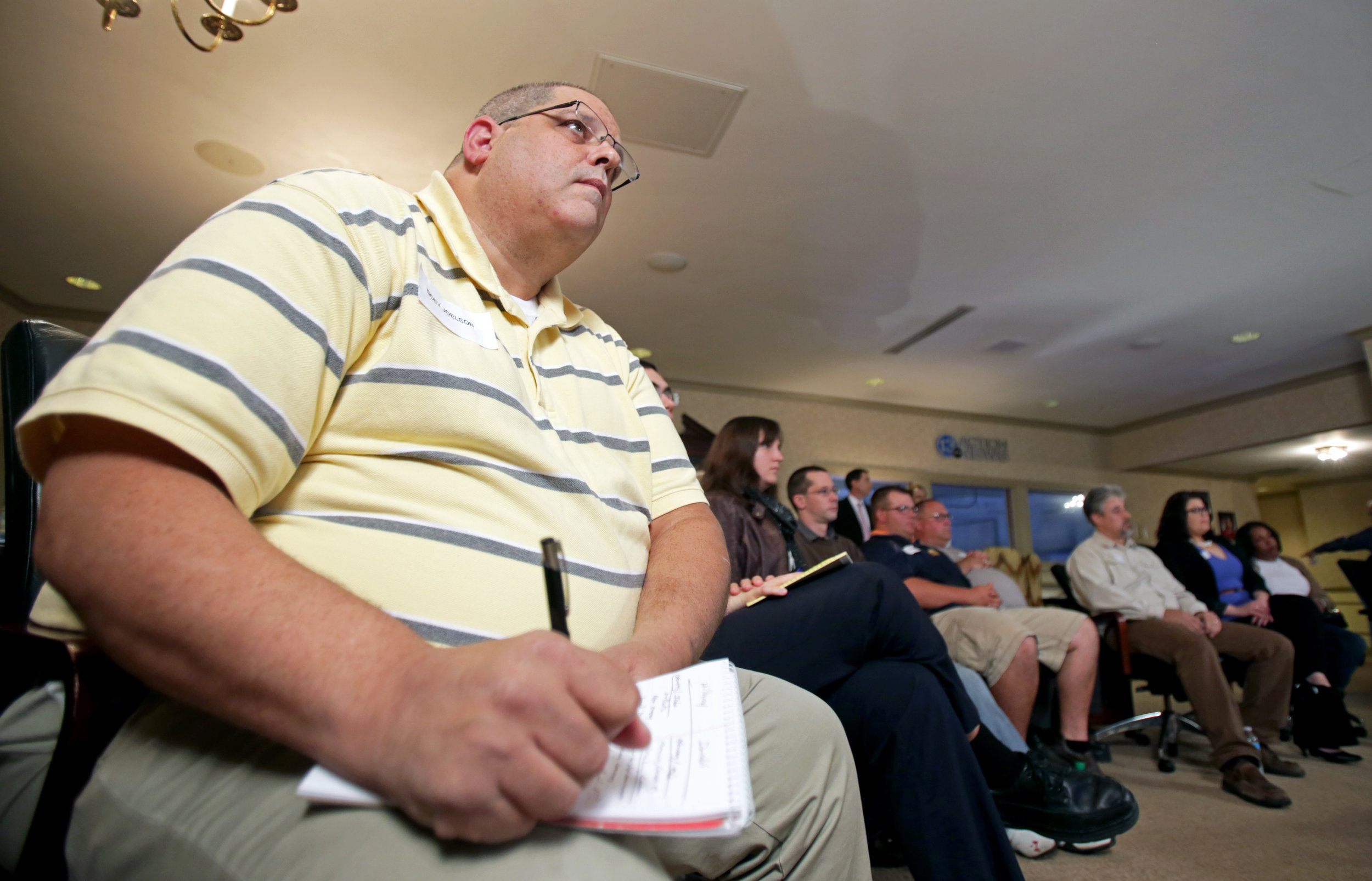 Undecided voter Doev Joelson of Sylvania takes notes on each of the candidates' points during a presidential debate viewing at the WTVG studio in Toledo on Monday, Sept. 26, 2016. 