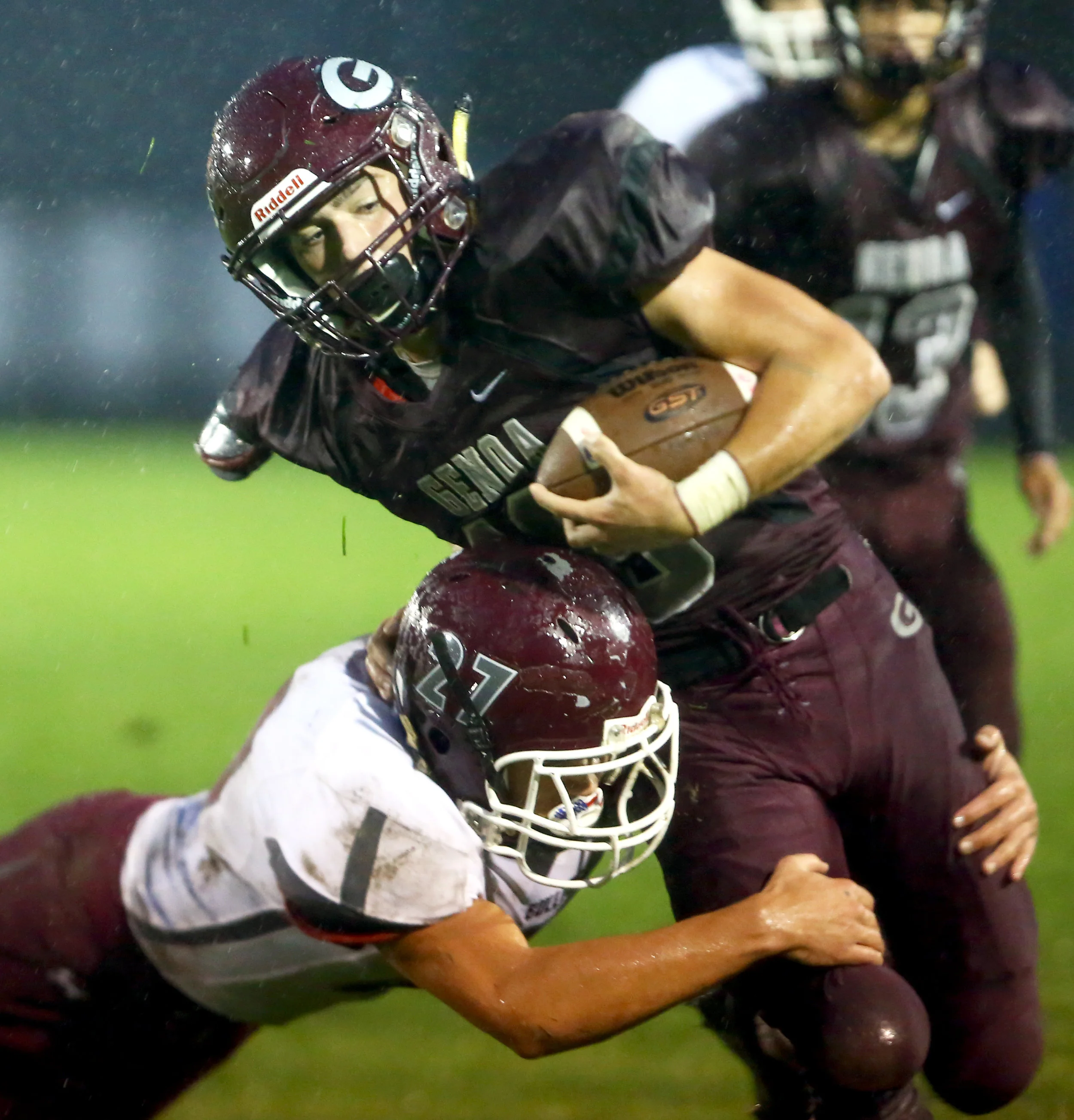 Genoa High School junior running back Josiah Bradfield is tackled by Rossford High School senior defensive back Jacob Perry during the football game at Genoa High School on Friday, Sept. 30, 2016.