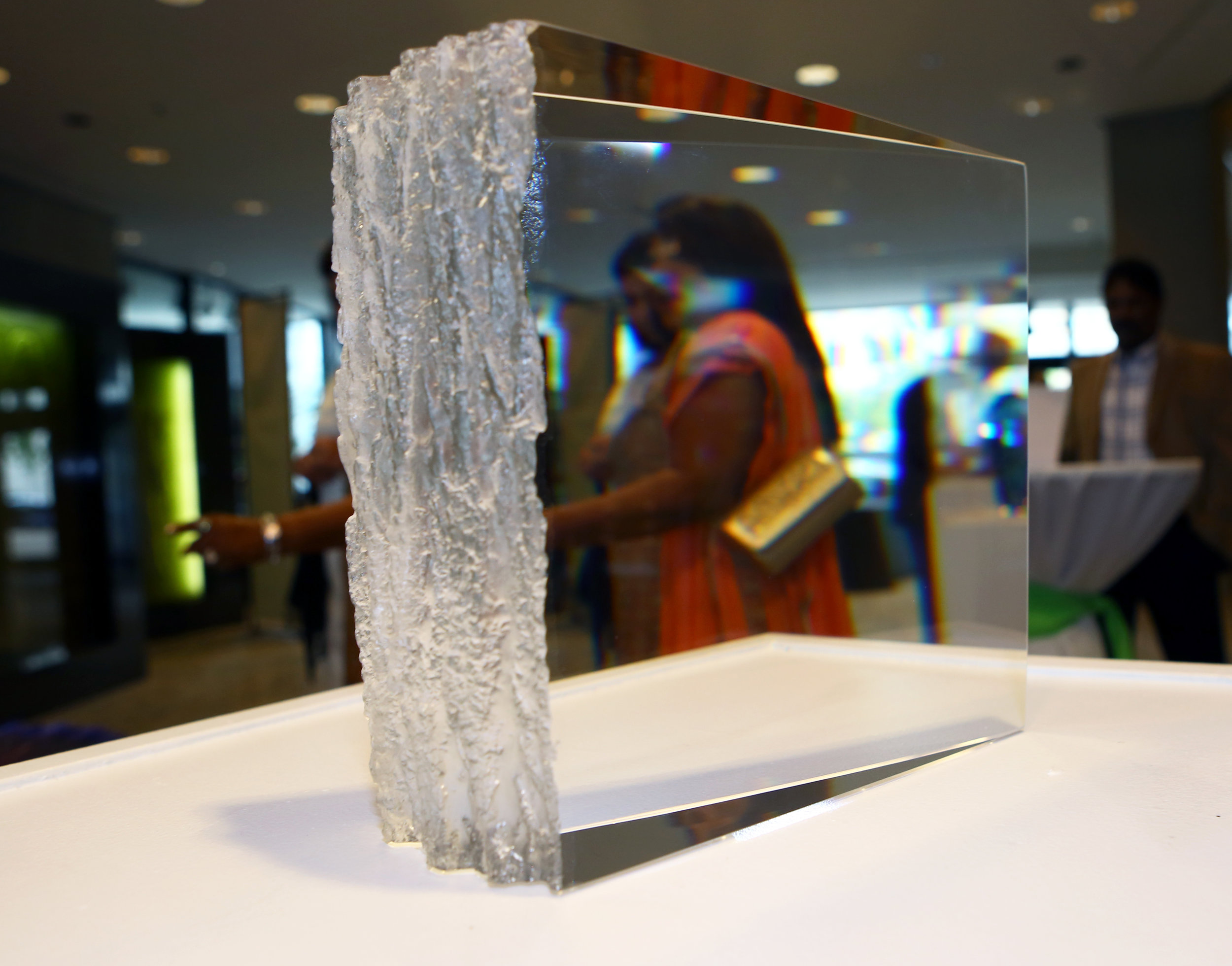 Attendees walk past the "White Pine" prism piece by Joel O'Dorsio during the Hot Shots! fundraiser benefitting The Arts Commission at the Edison Building in downtown Toledo on Saturday, October 1, 2016. 