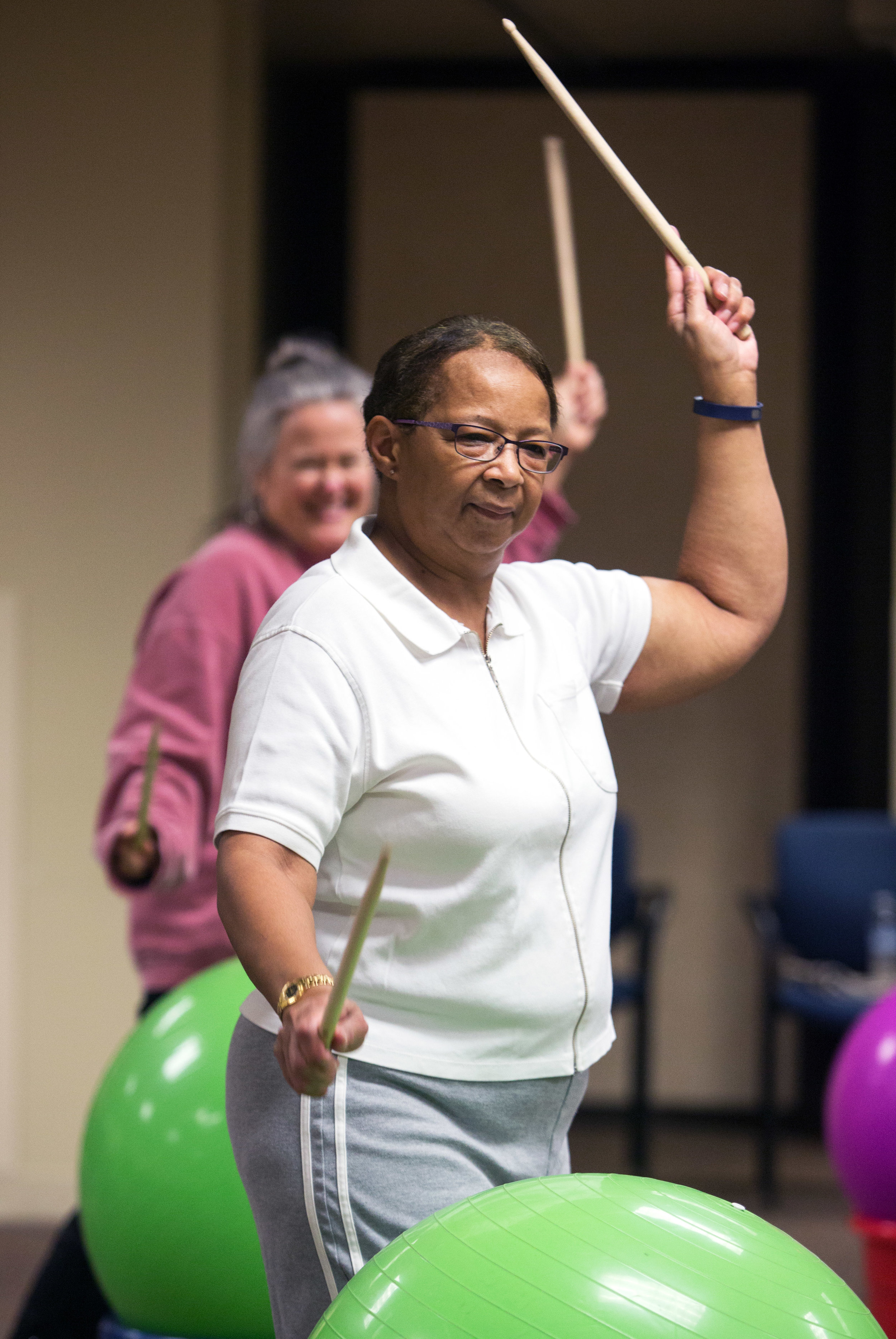 Sheila Googins of Toledo, front, and Marnie Arndt, back, follow along with a choreographed routine during the weekly cardio drumming for cancer survivors work out in the Heath and Human Services Building at University of Toledo on Thursday, Oct. 20, 2016.