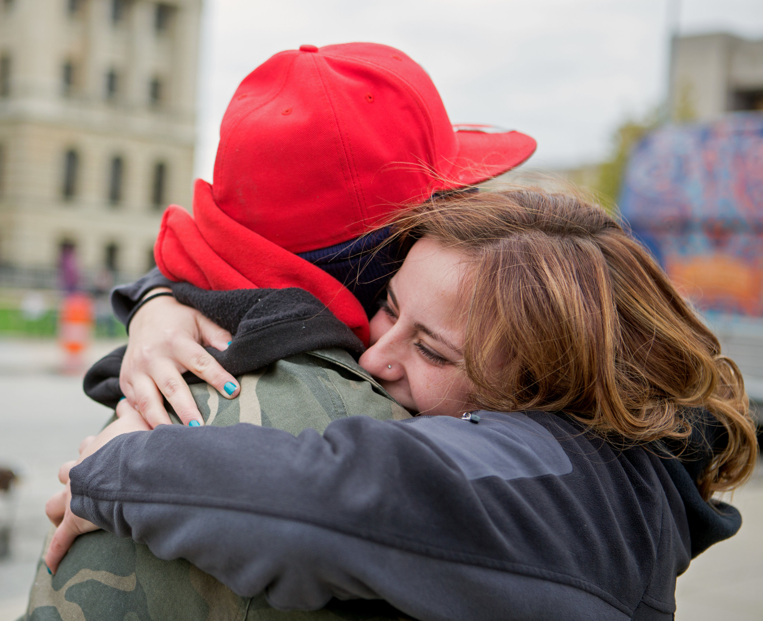 Former Tent City mayor Selena Green hugs clothing tent volunteer Terrance Burch before the start of Tent City at Civic Center Mall in Downtown Toledo on Friday, Oct. 21, 2016.