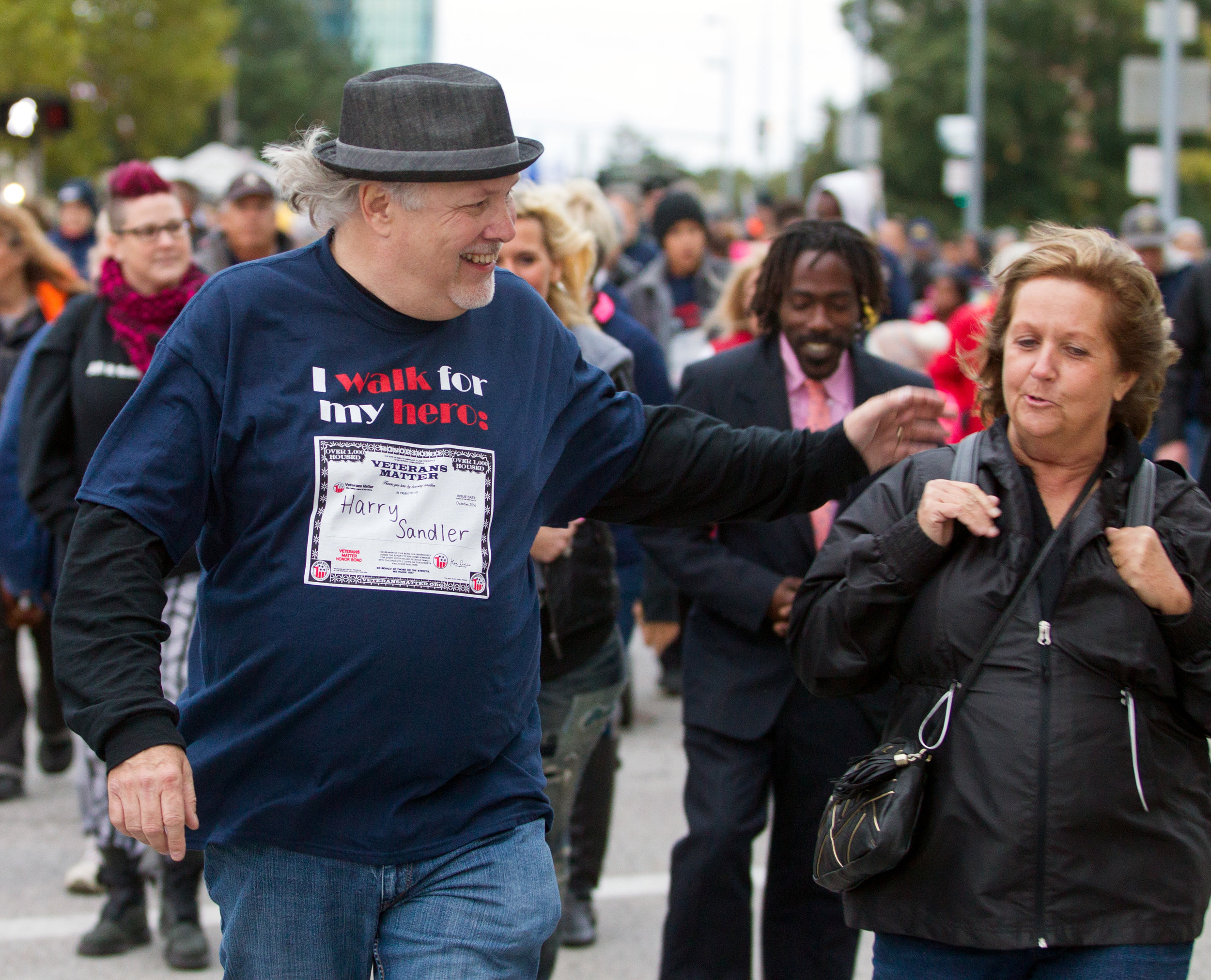Veterans Matter advocate in chief Ken Leslie speaks with other participants as he leads the Walk to End Veteran Homelessness down Jackson St. in Downtown Toledo on Friday, Oct. 21, 2016.