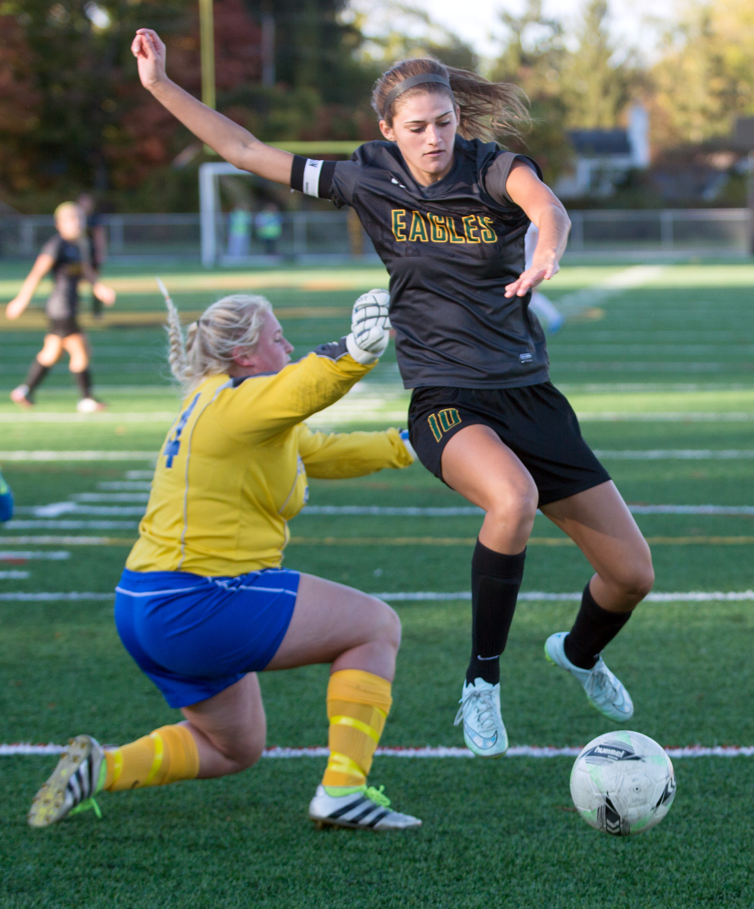 Karleigh Clere of Clay High School jumps passed St. Ursula's goal keeper Caelan Warneke during the Division I girls soccer district tournament at Northview High School Monday, Oct. 24, 2016.