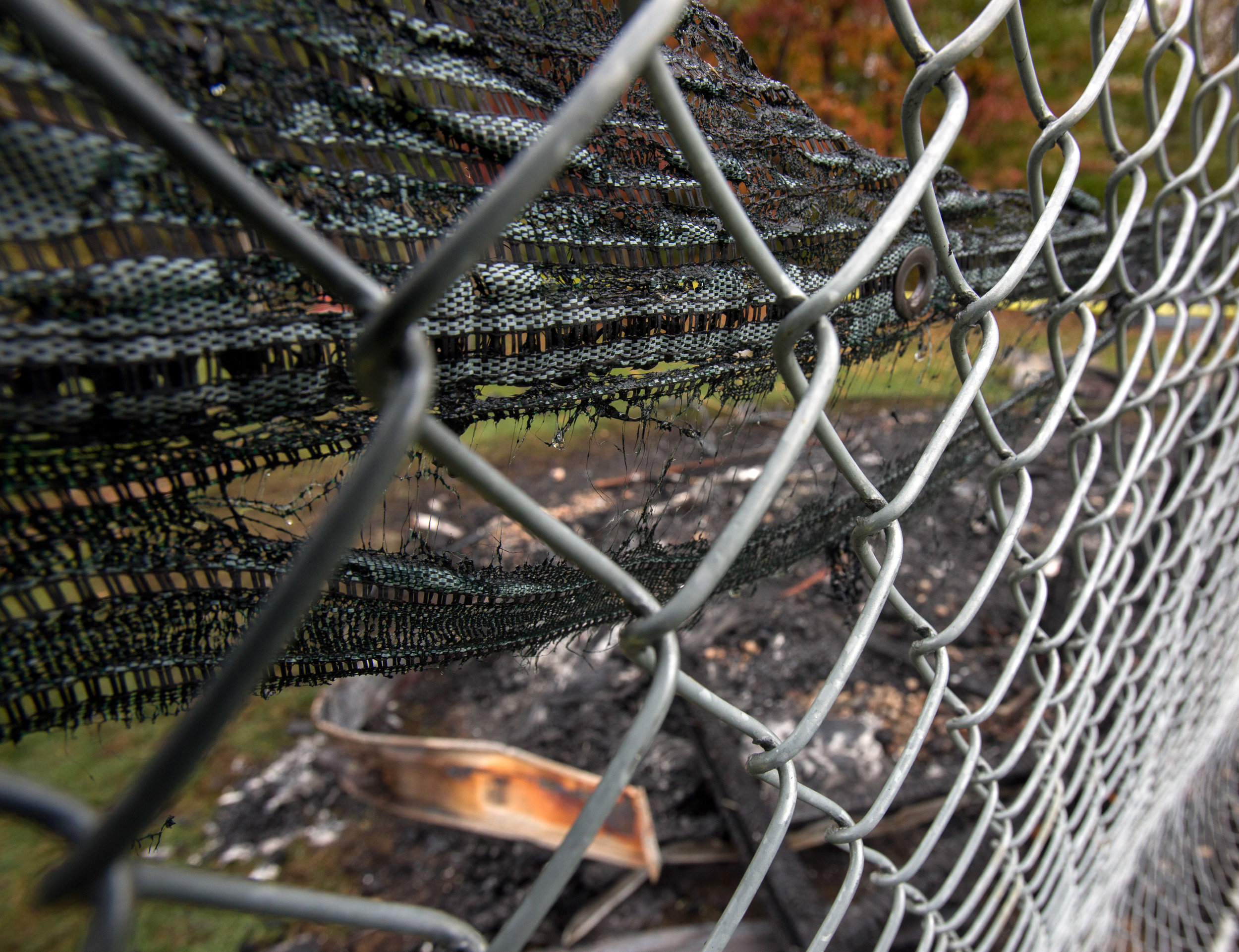 The melted backstop netting and charred remains of a storage shed holding baseball equipment behind Bedford Middle School in Temperance, Mi. that burned down early Wednesday morning photographed on Wednesday, Oct. 26, 2016. 