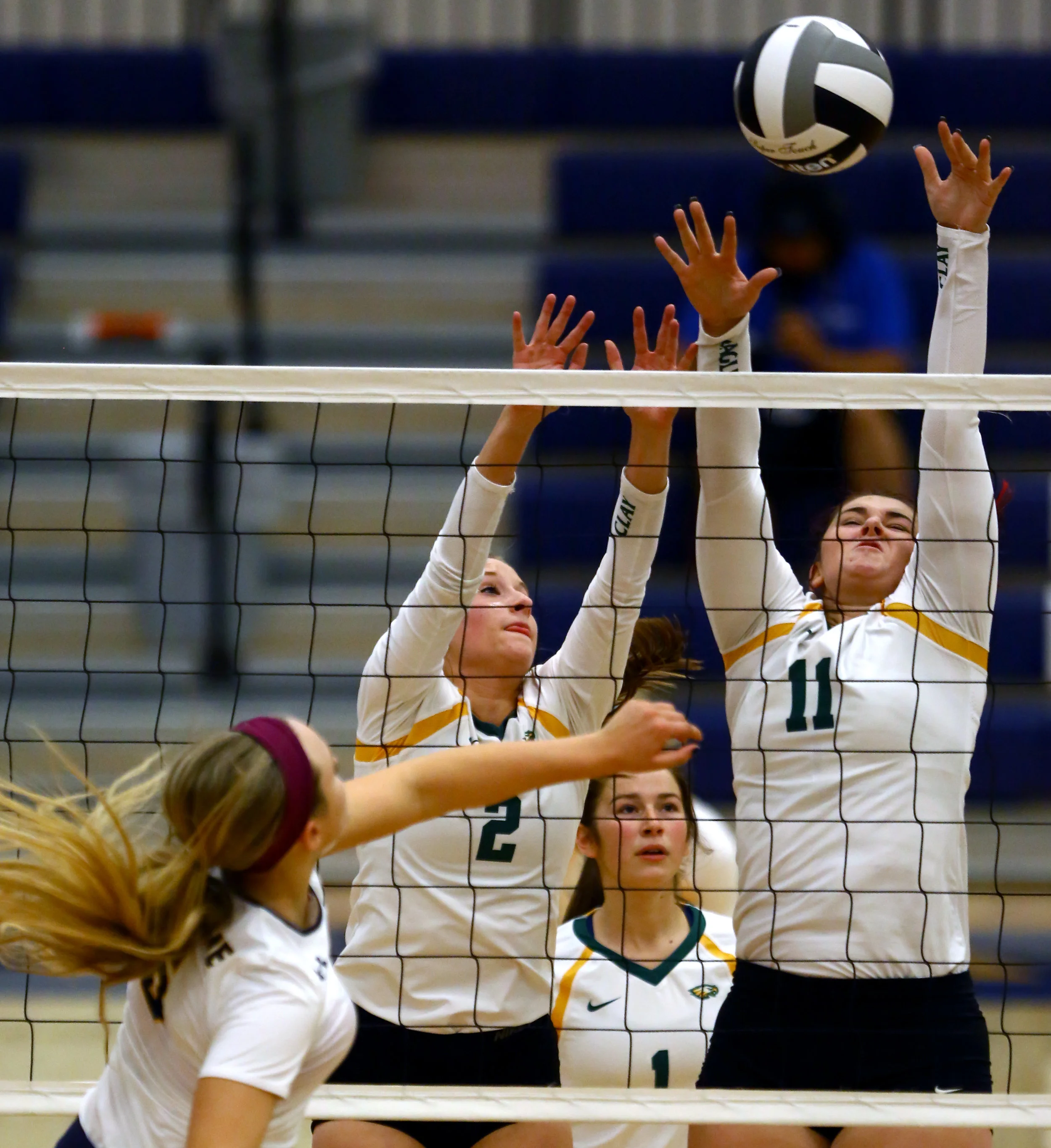 Clay High School setter Abby Batch (2) and middle hitter Alyssa Huffman (11) jump as a hit from Notre Dame Academy right side hitter Cassandra Calamunci goes over their block during the Div. 1 volleyball district final at Lake High School in Millbury, Oh. on Saturday, Oct. 29, 2016. Notre Dame Academy won the match 3-0.
