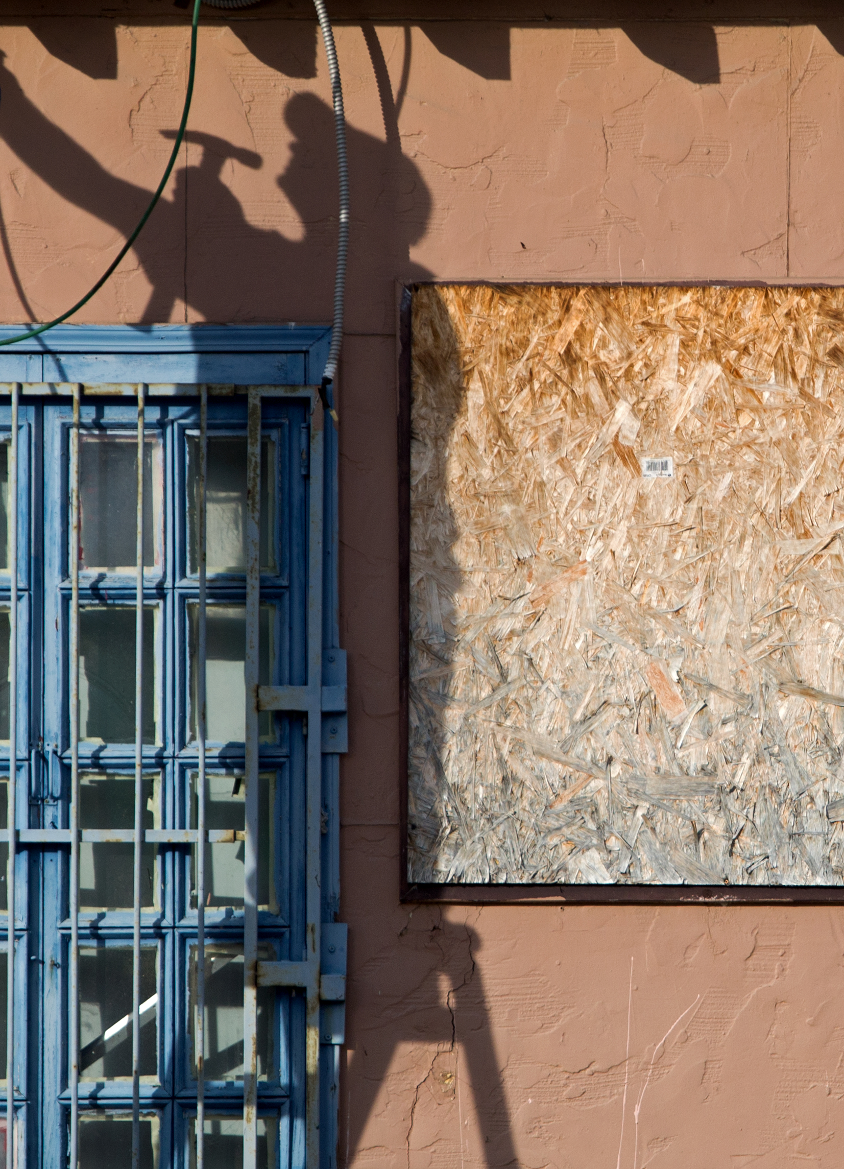 Owner of the property Jim Hammoudi casts a shadow on the building on the the corner of Broadway and Orchard St. that he works on in Toledo on Tuesday, Nov. 1, 2016.