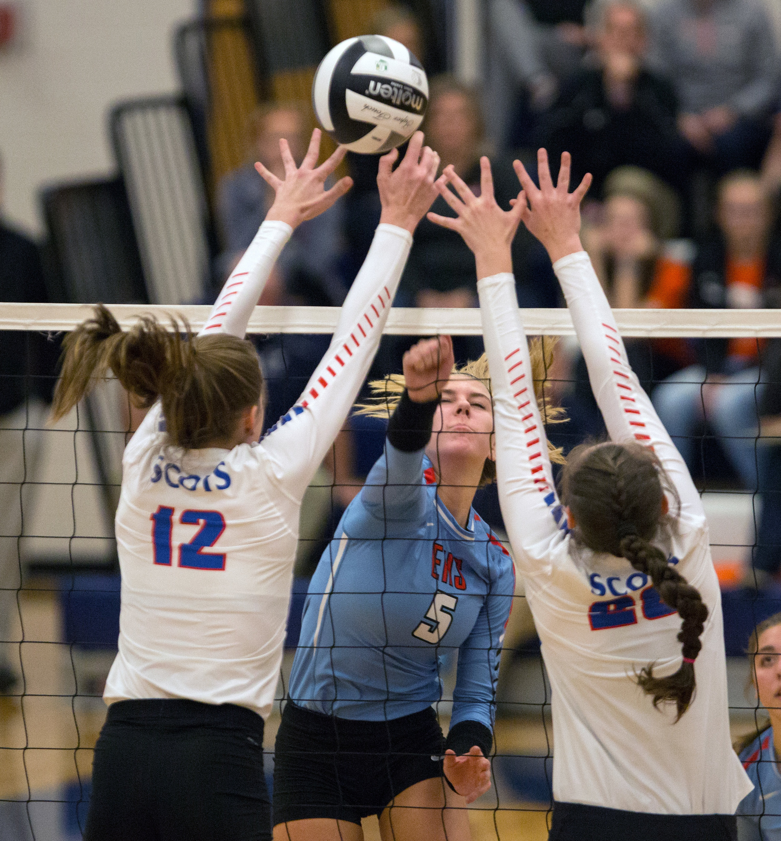 Eastwood High School setter Abby Schroeder's (5) hit is blocked by Highland High School outside hitter Raina Terry (12) and middle hitter Gena West (28) during the Div. 3 volleyball final at Lake High School on Thursday, Oct. 3, 2016. Highland High School won the match 3-0.