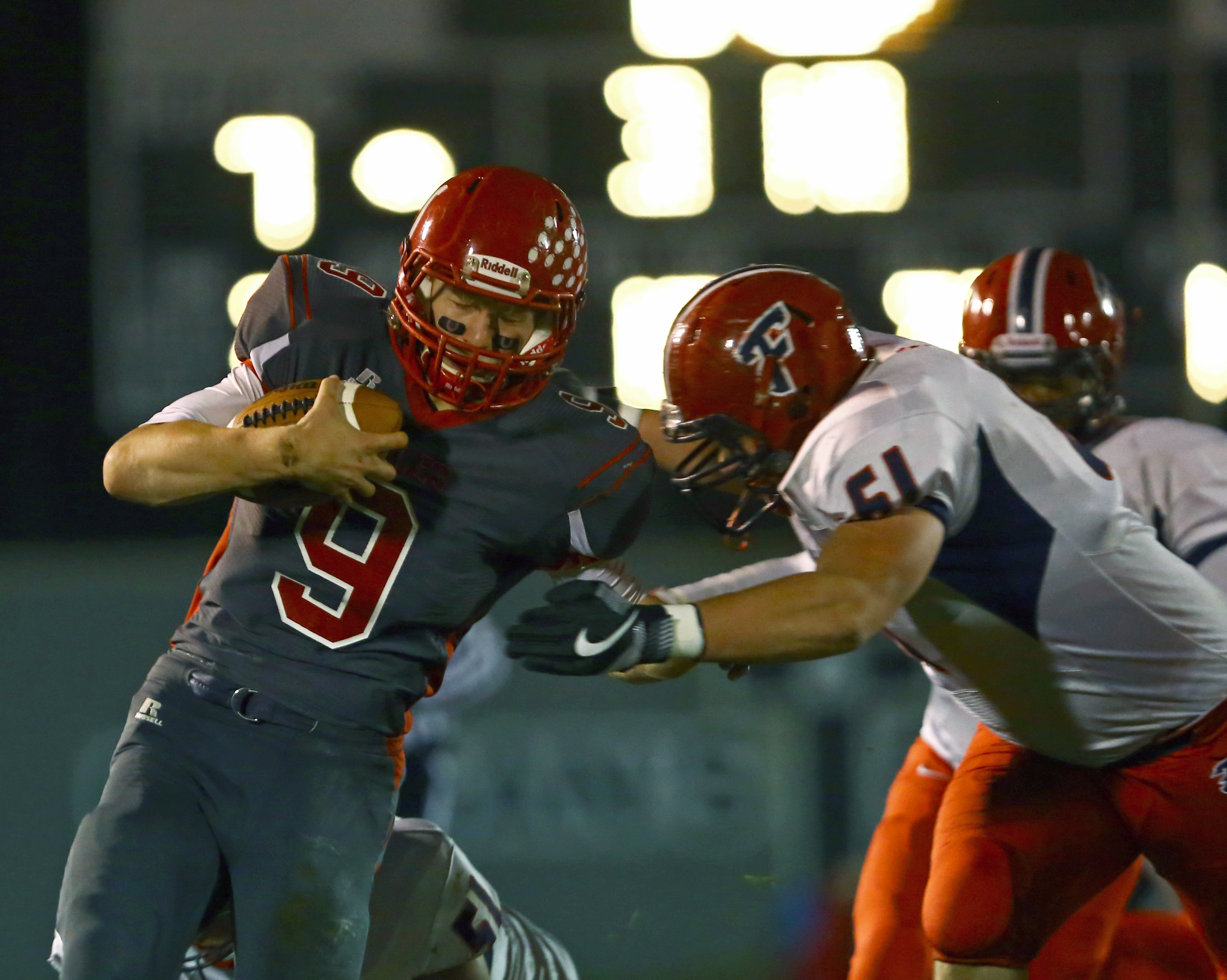 Bedford High School quarterback Joey Wiemer (9) braces for a tackle from Franklin High School defensive lineman Devin Visnaw (61) during the football game at Bedford High School in Temperance, Mi. on Friday, Nov. 4, 2016.