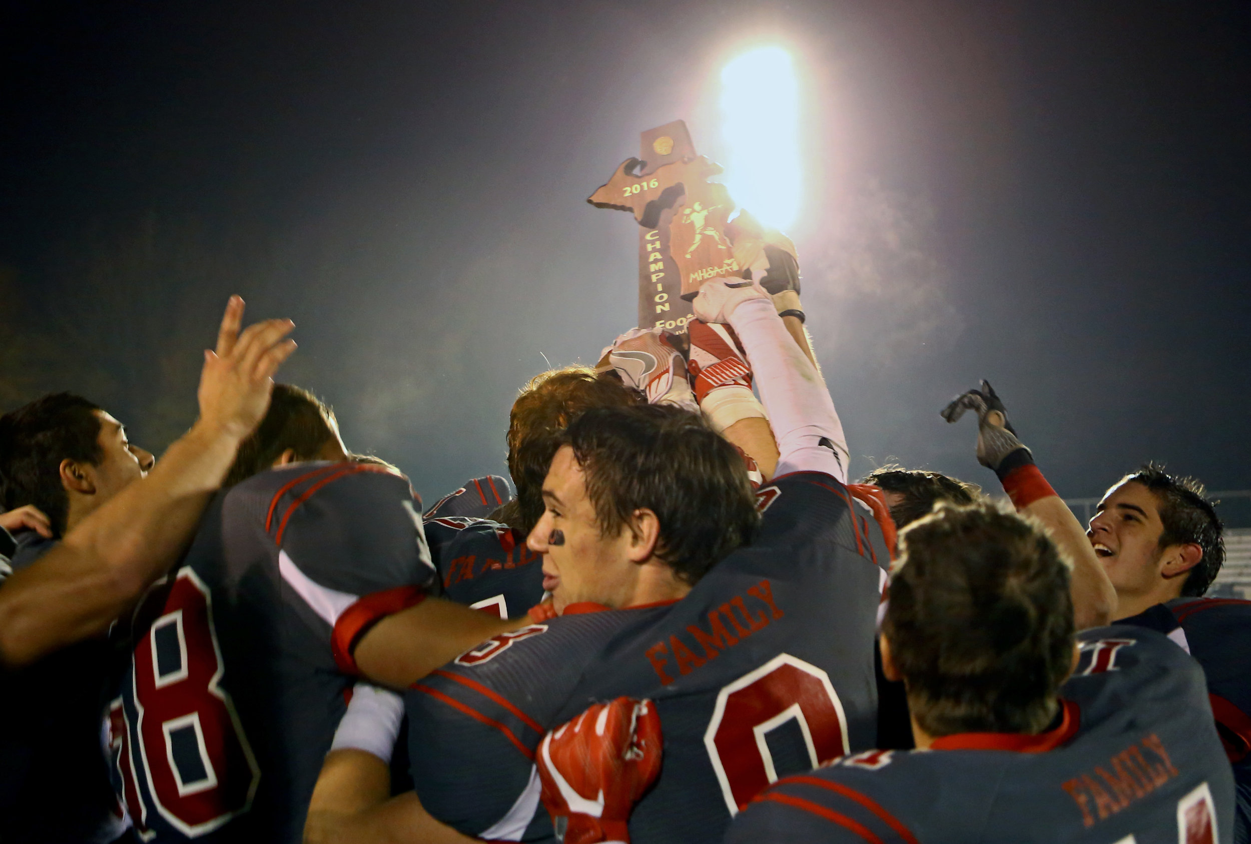 Members of the Bedford High School football team celebrate after receiving the MSHAA Div. 2 Champions trophy after their 39-22 victory over Franklin High School at Bedford High School in Temperance, Mi. on Friday, Nov. 4, 2016. 