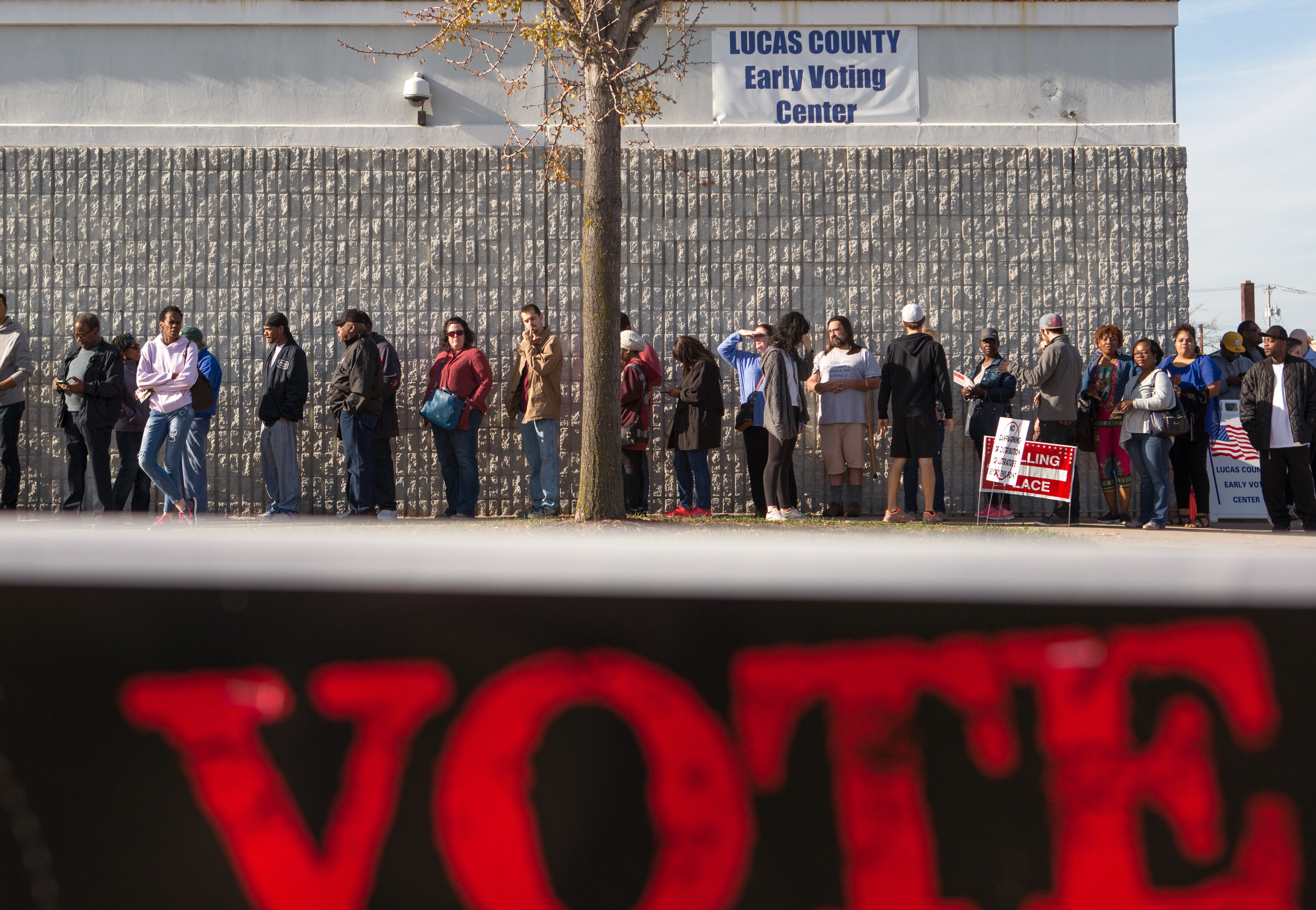 Early voters wait in a line that wraps around the outside of the Lucas County Early Voting Center on Monroe St. in Toledo to cast their vote in the upcoming election on Saturday, Nov. 5, 2016.