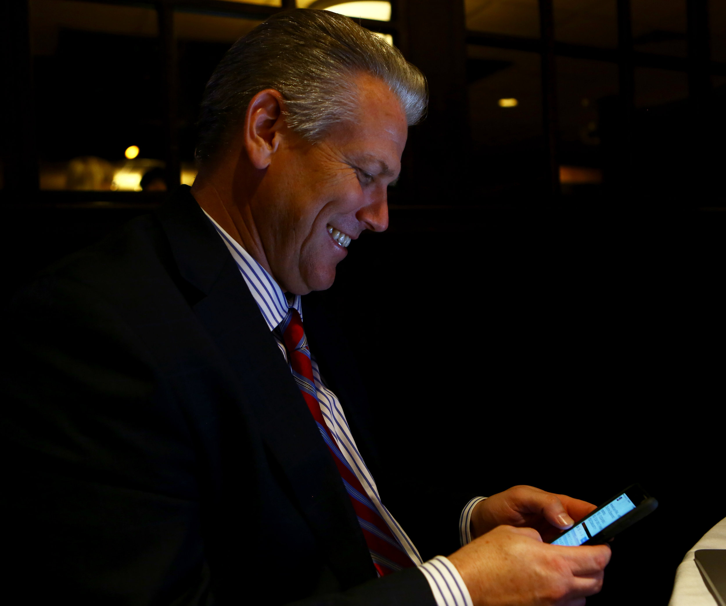 Perrysburg school district superintendent Tom Hosler smiles as he tweets out the passing results of the Perrysburg school renewal operating levy at the Holiday Inn French Quarter in Peerysburg on Tuesday, Nov. 8, 2016.