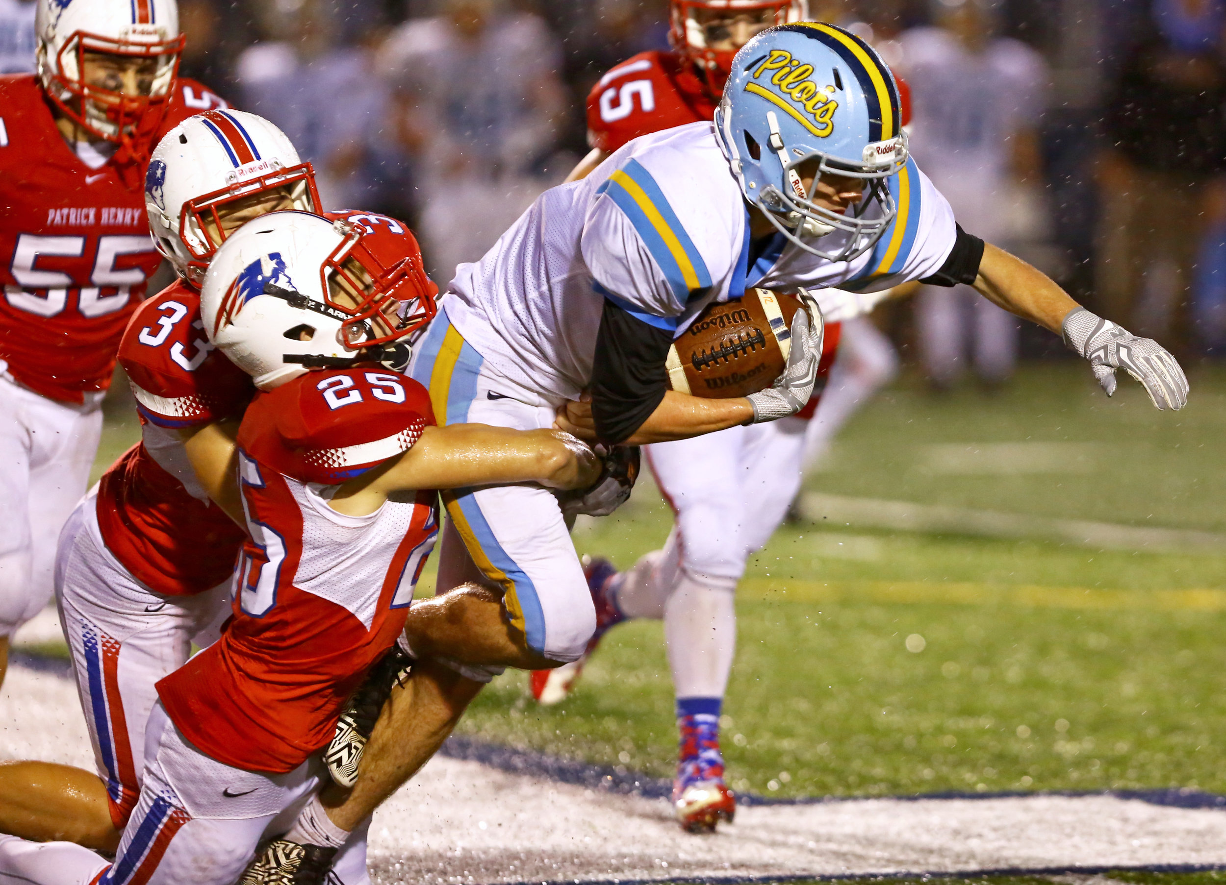 Ayerville High School defensive back Mikey McGuire (1) is brought down midfield by Patrick Henry High School defensive backs Brock Gerken (25) and Steven Diem (33) during the OSHAA Div. VI final football game at Napoleon High School in Napoleon, Oh. High School on Friday, Nov. 18, 2016. Patrick Henry won the game 21-19.