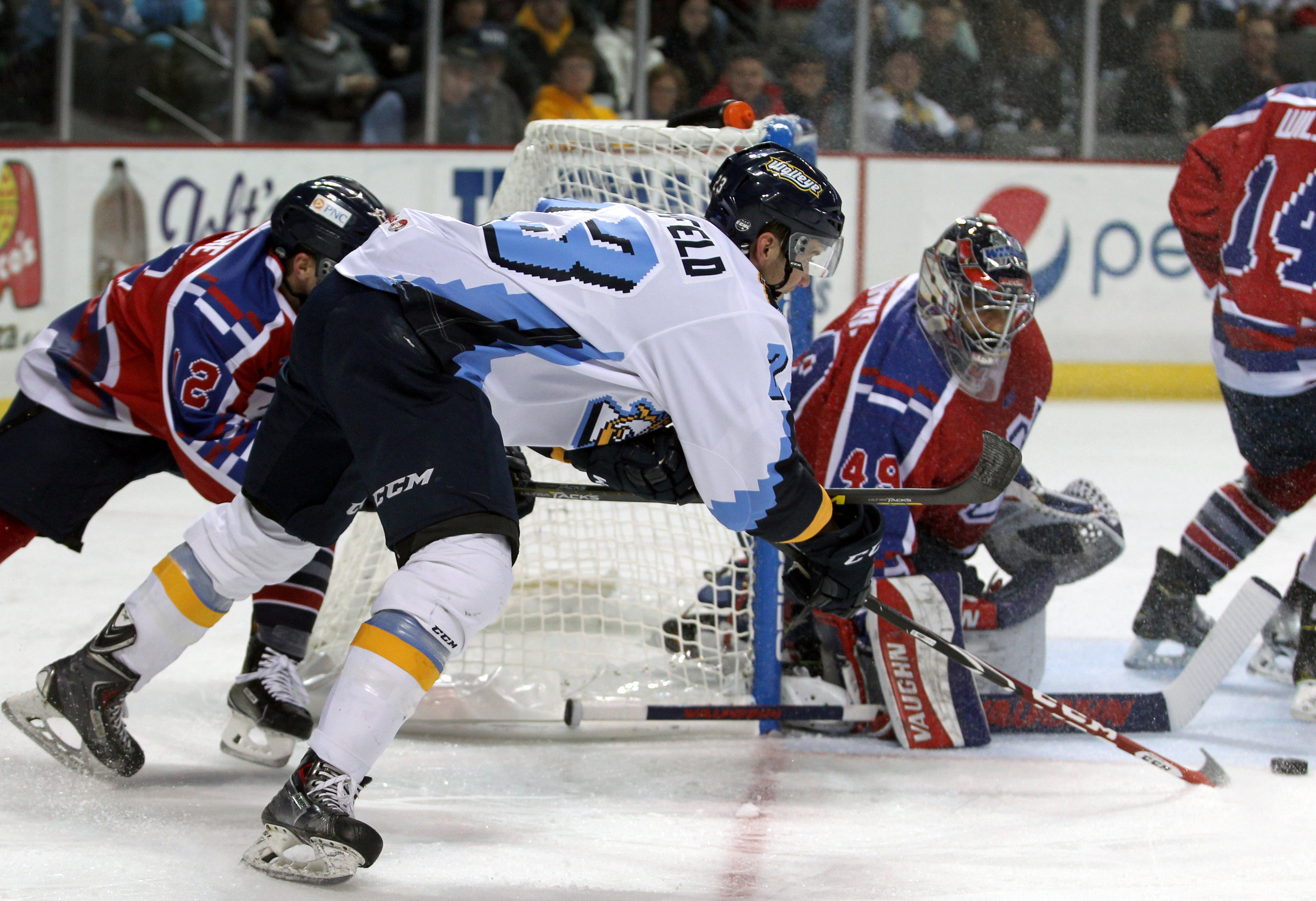 Toledo Walleye forward Alden Hirschfeld (23) hooks the puck around Kalamazoo Wings goalie Joel Martin (49) during the hockey game at the Huntington Center in downtown Toledo, Oh. on Saturday, Nov. 19, 2016. The Walleye won the game 6-2.