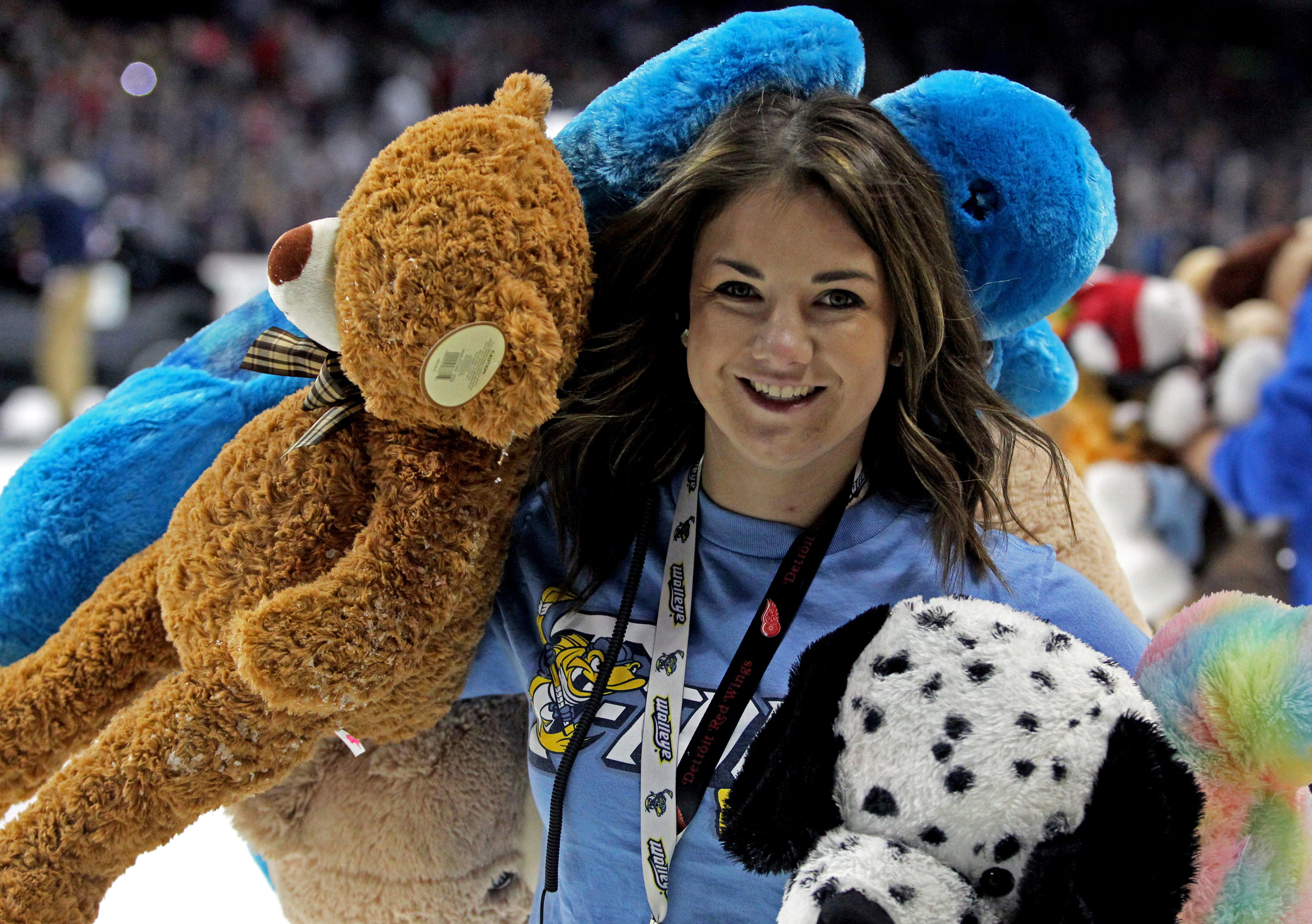 Toledo Walleye Pond Patrol member Ashely Lonsway of Bedford, Mi. carries handfuls of teddy bears off of the ice to be donated to local charities after the annual Teddy Bear Toss during the Walleye game against the Quad City Mallards at the Huntington Center on Saturday, Dec. 3, 2016.