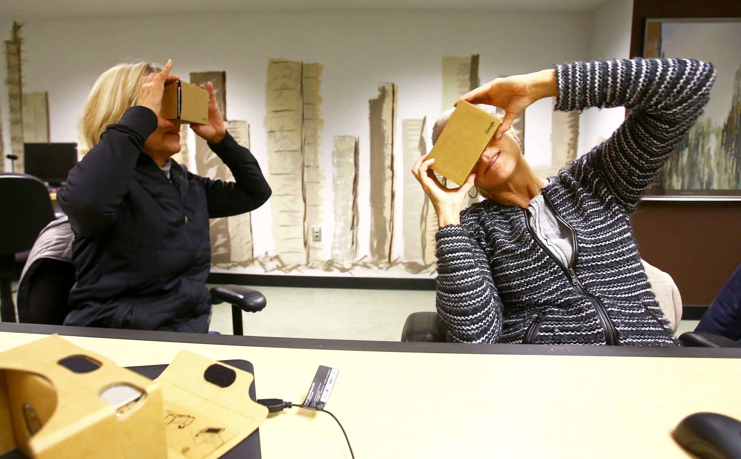 Carol Martin of Toledo, left, and Annie Yunger of Holland test out their freshly assembled Google Cardboard virtual reality headsets during a Make and Take: Build your own Virtual Reality Headset class held at the Way Public Library in downtown Perrysburg, Oh. on Monday, Dec. 5, 2016. Yunger was brought along with Martin who signed up for the class because she wanted to stay up to date on the latest technology for her grandchildren.