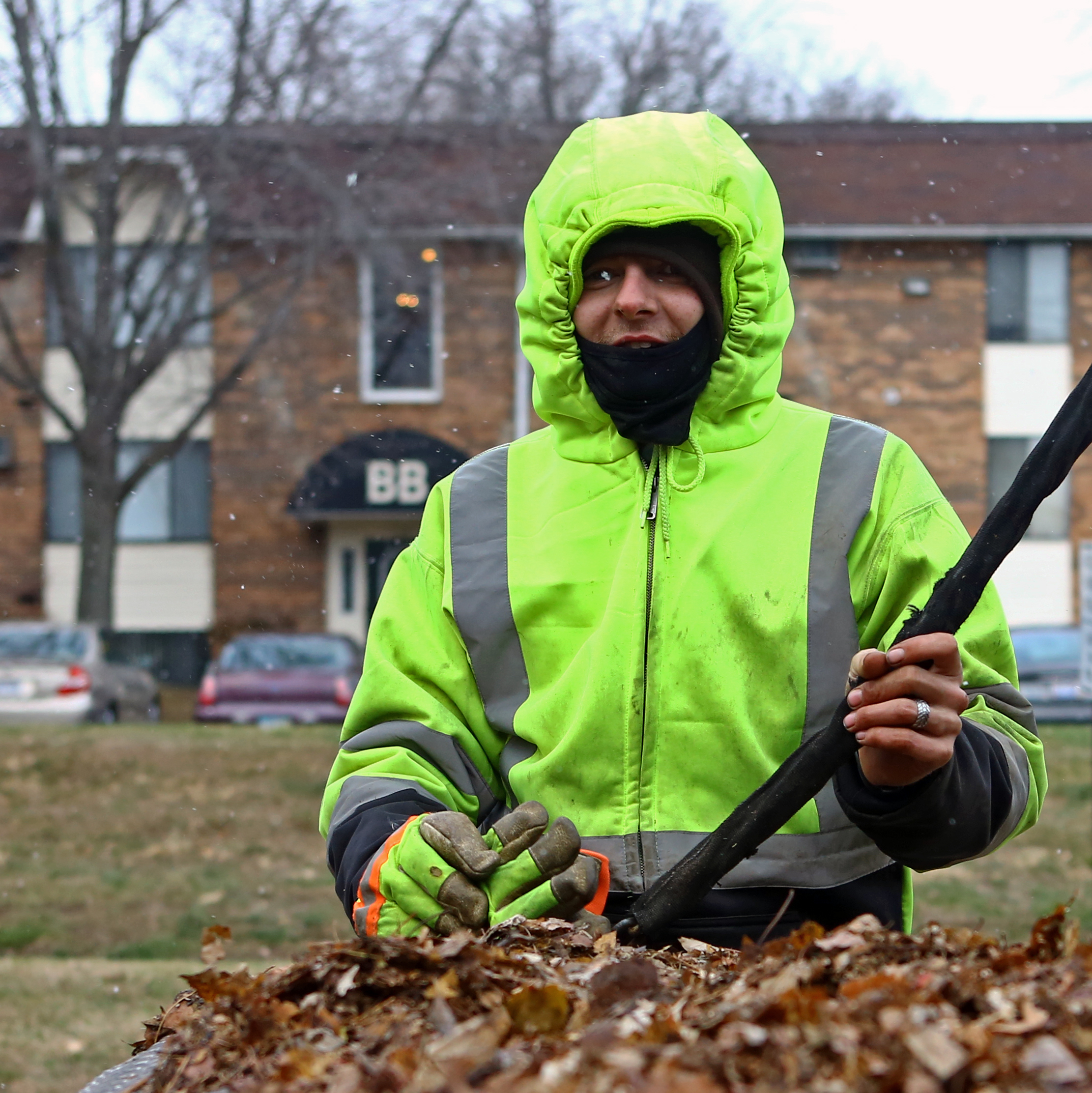 Joey Smith of Delta is bundled up while working with Total Package Landscaping clearing leaves from the Hunter's Ridge apartment complex on Byrne Rd. in Toledo on Thursday, Dec. 8, 2016. 