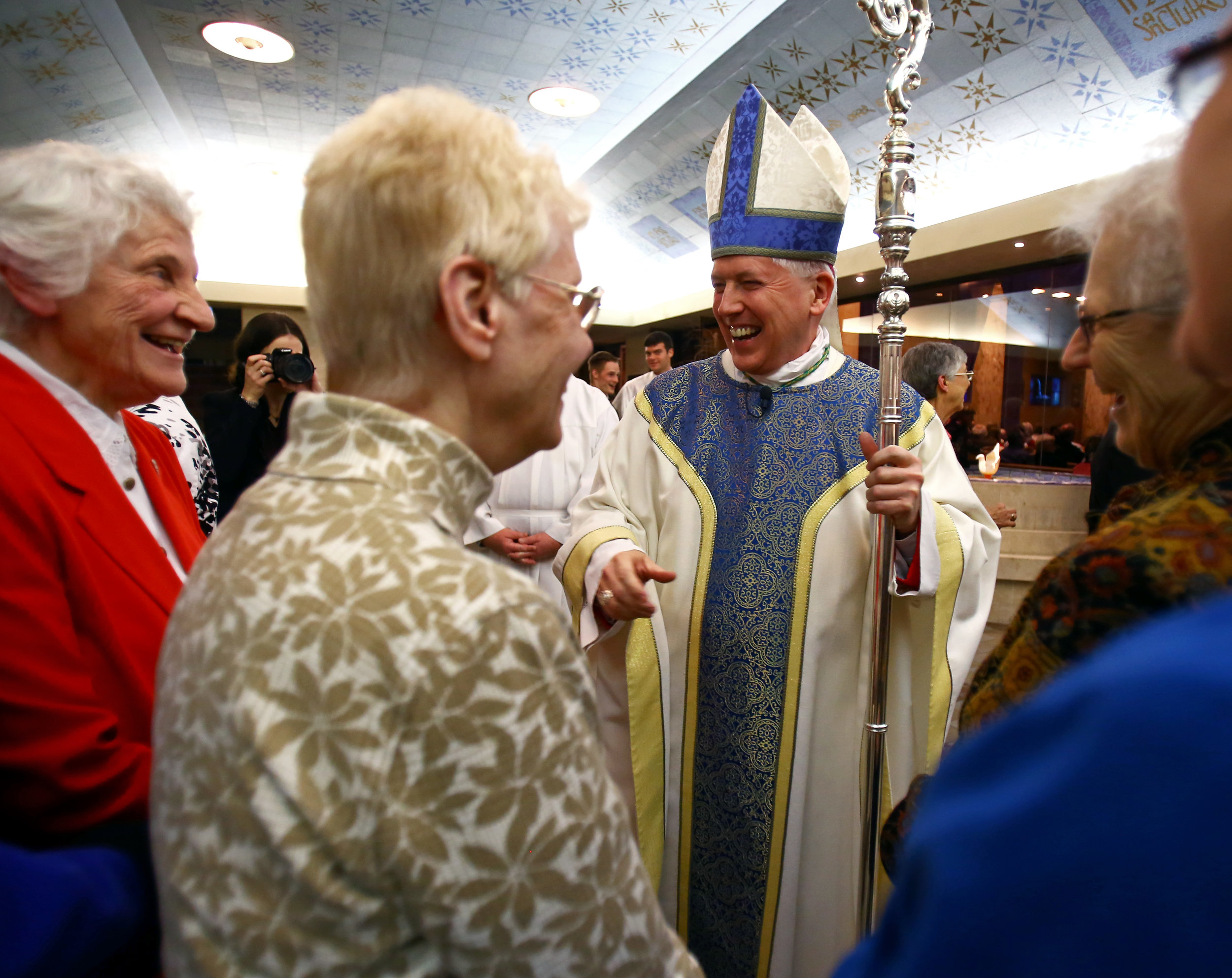  Bishop Daniel Thomas greets the Sisters of St. Francis before the start of the 100th anniversary mass of the Sisters of St. Francis held at the Queen Chapel in Sylvania on Thursday, Dec. 8, 2016. 
