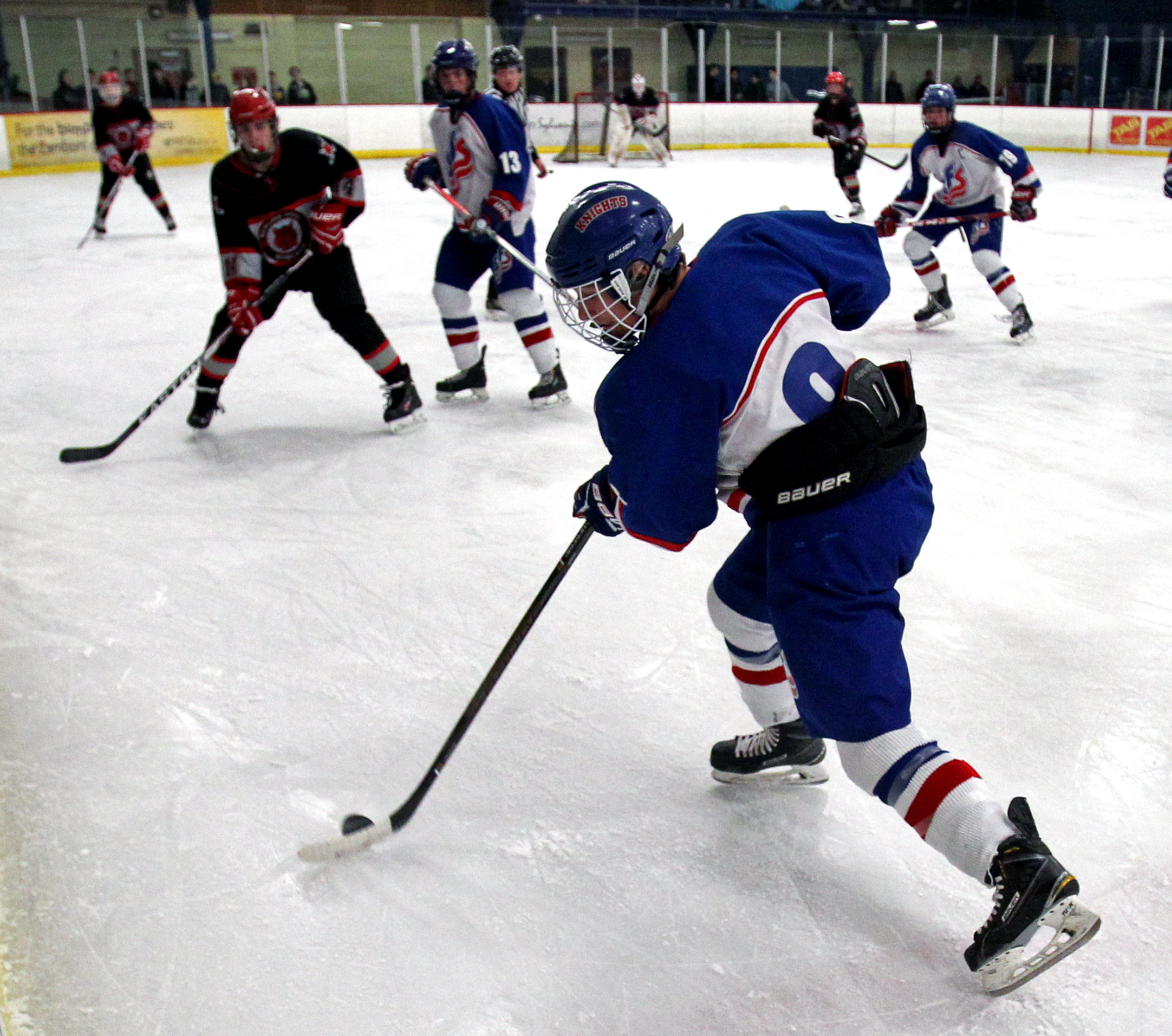 St. Francis de Sales defender Nick Kozma (8) moves the puck down rink while Bowling Green High School's Ryan Tyrrell blocks his path during the boy's hockey game at Tam-O-Shanter ice Arena in Sylvania Oh. on Friday, Dec. 9, 2016. 