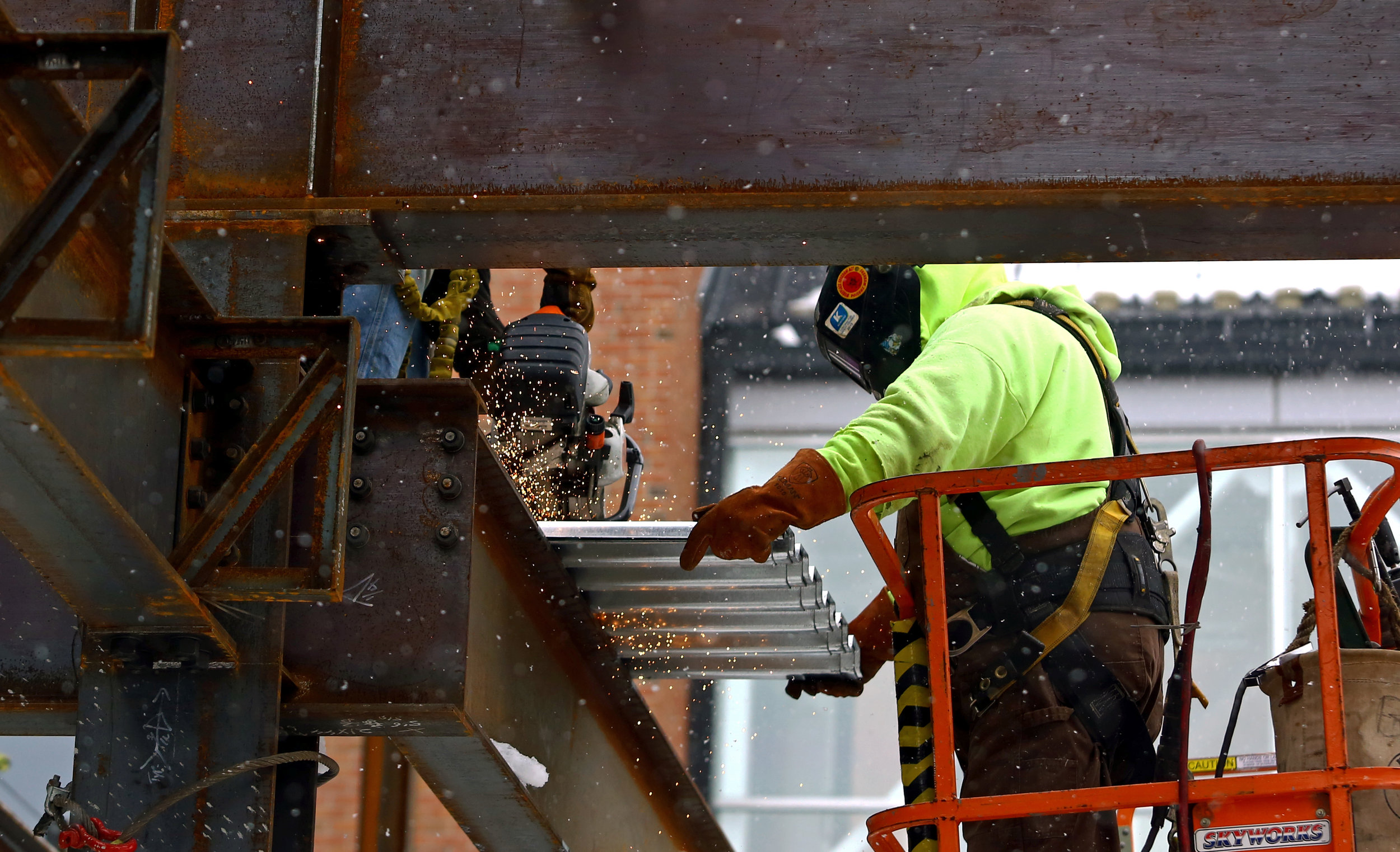 Adam Wilbur, left, of Toledo and Robert Bacon, right, work on cutting sections of roofing for the new emergency wing under construction at Mercy St. Vincent Hospital on Cherry Street in Toledo, Oh. on Tuesday, Dec. 13, 2016. 