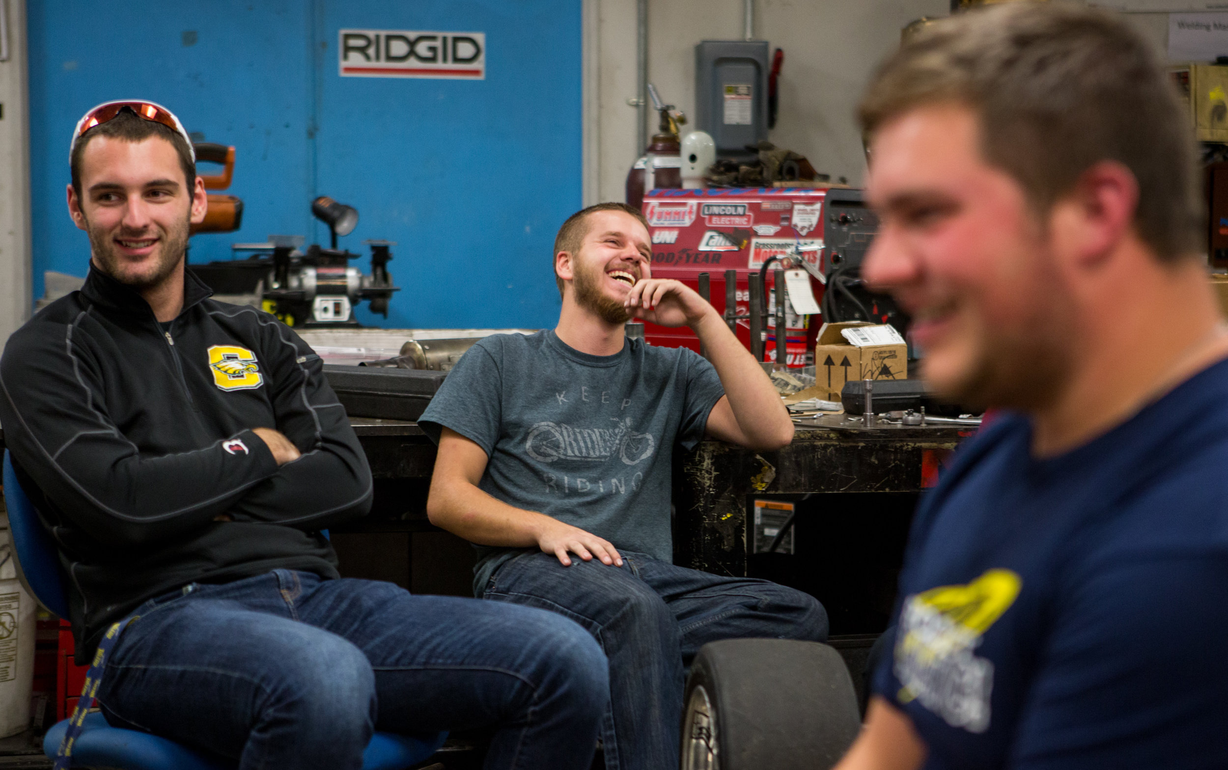  Jared Schaufele, left, and Colton Niese laugh with the rest of the team during one of their weekly planning meetings in the Formula SAE team lab. 