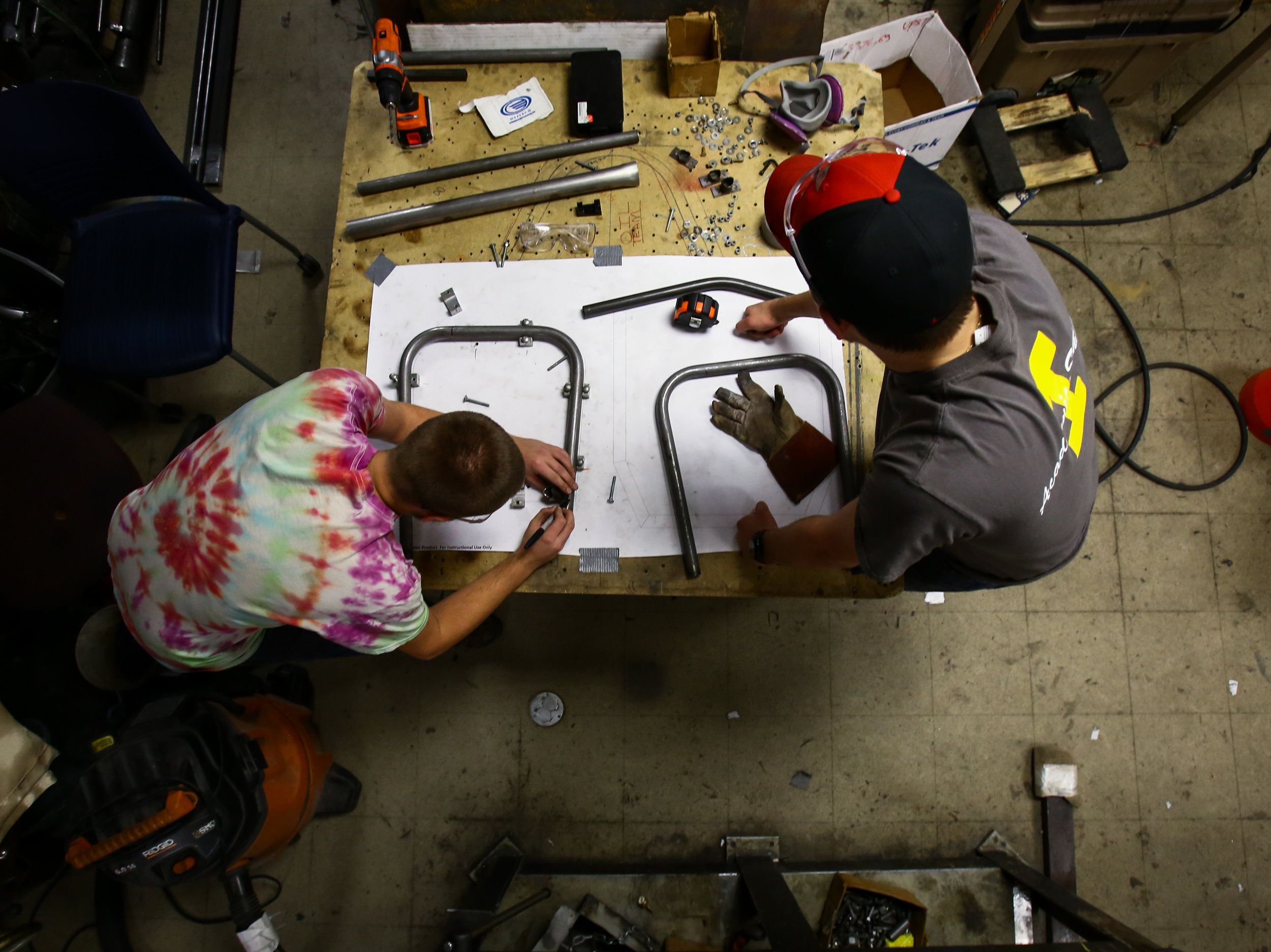  Jared Schaufele, left, and Colin Jedrzejek work on marking and cutting tubing to weld together the front bulk head as they begin to construct the chassis for the current season’s car in the Formula SAE team lab in the University of Toledo’s North En