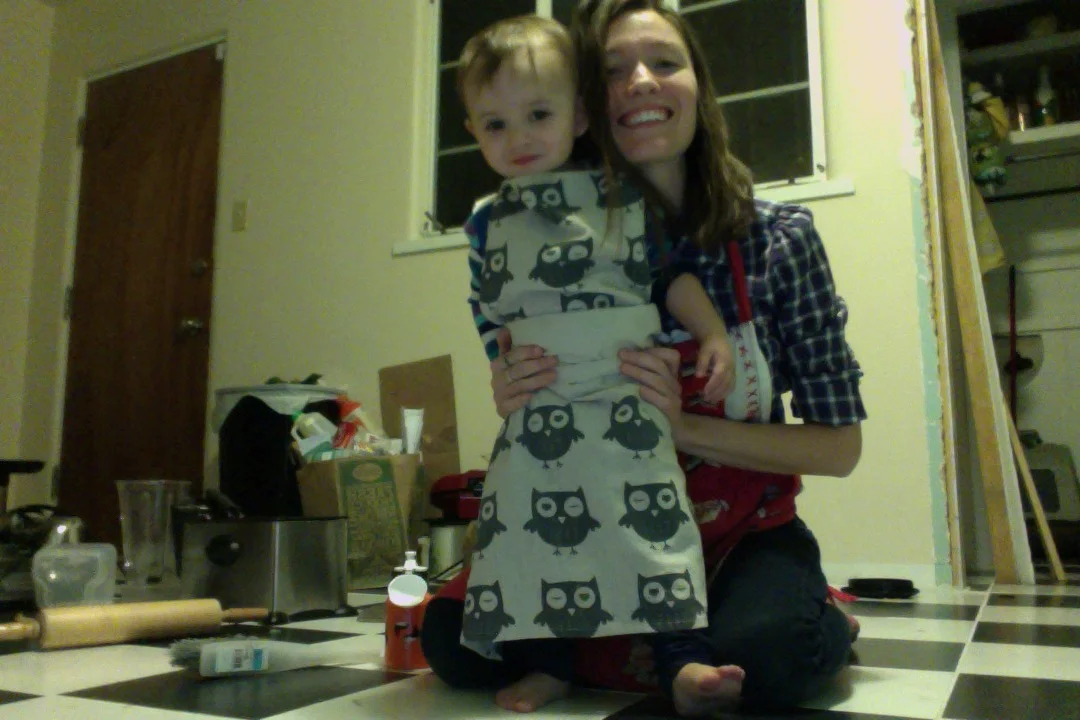 Maybe it's that with her has come the explosive mess bomb of everything we own. But then look at the big apron wrapped on her little body. It makes up for it all! 