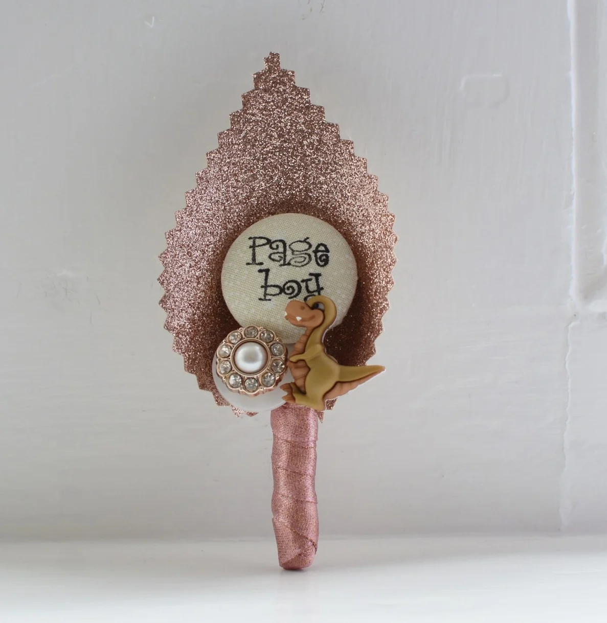 Rose Gold Page Boy Wedding Buttonhole with Dinosaur