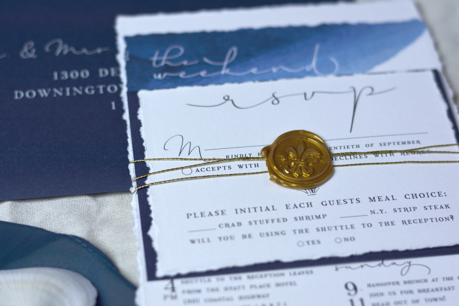Pro Tip: we used metallic gold hot glue sticks instead of sealing wax for this suite. Why? For a few reasons, but the most important being that sealing wax is very brittle and can break easily, especially when the USPS is involved. Also, we didn't want the wax to rub off any color on the RSVP card below. So, we used hot glue sticks instead and it worked like a charm!